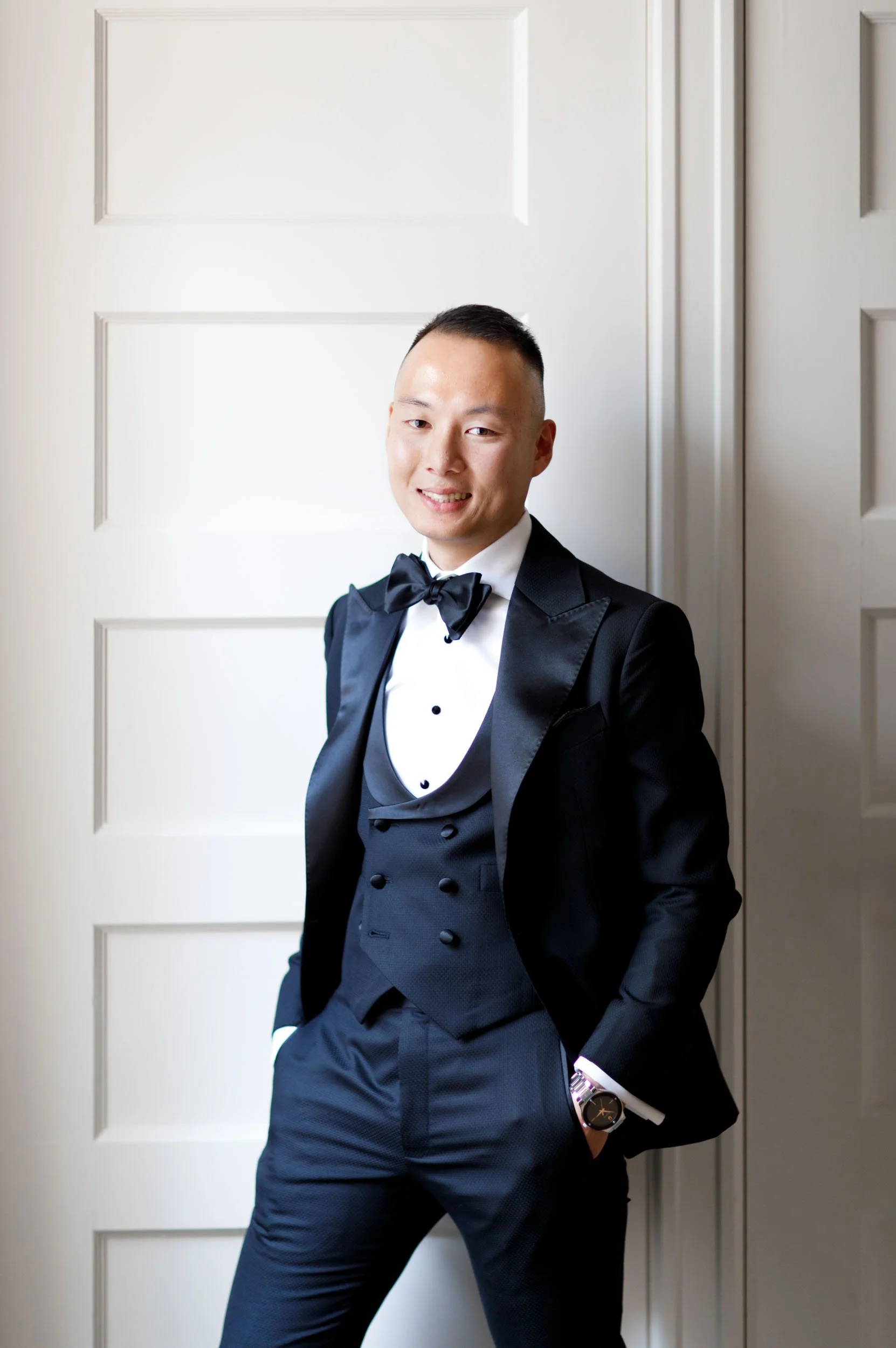 Groom portrait in black tie attire at Omni King Edward Hotel