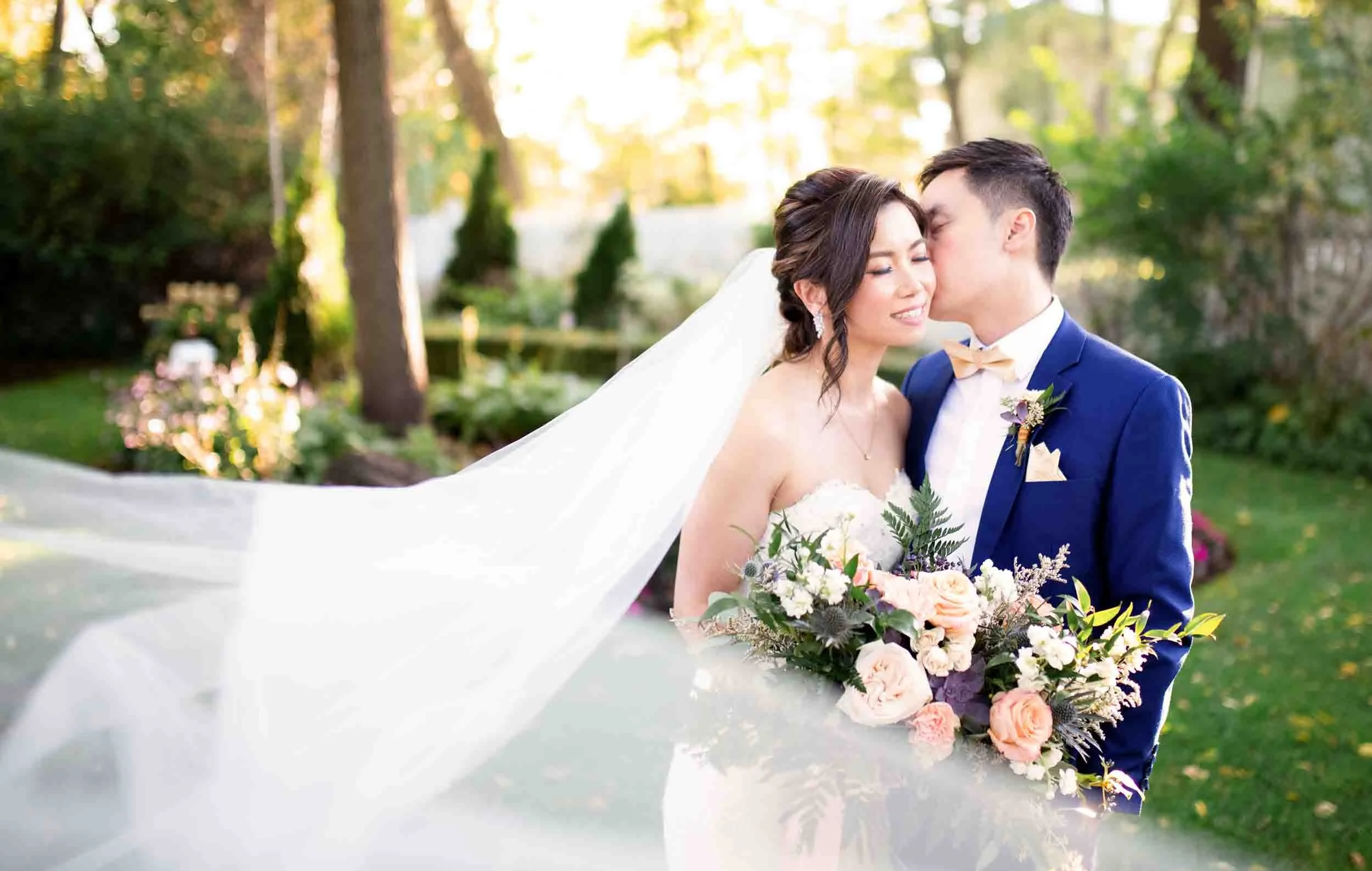 Romantic blowing bridal veil portrait in garden at The Doctor’s House wedding in Kleinburg, Ontario