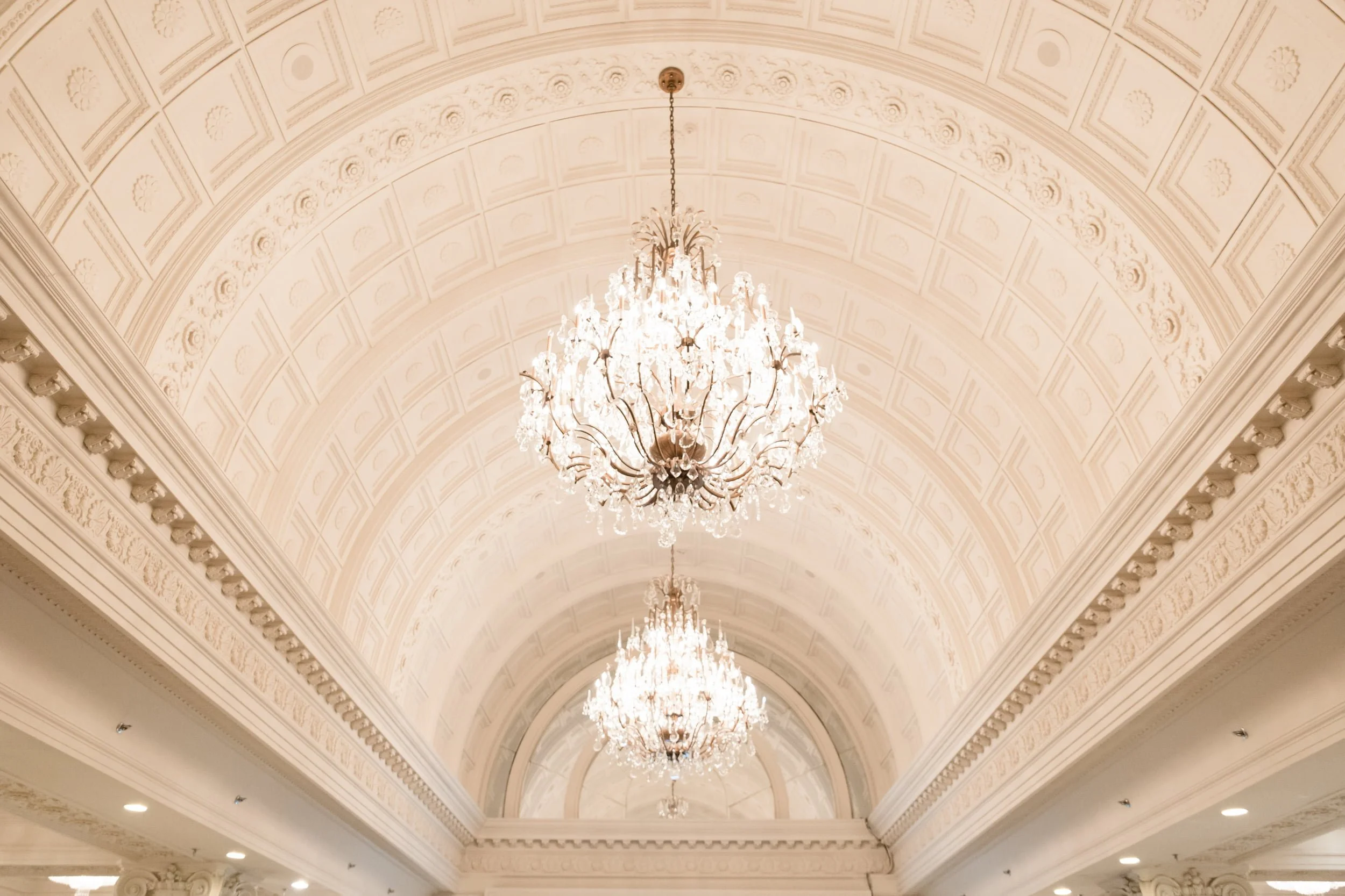Ornate chandelier ceiling inside the Crystal Ballroom at Omni King Edward Hotel