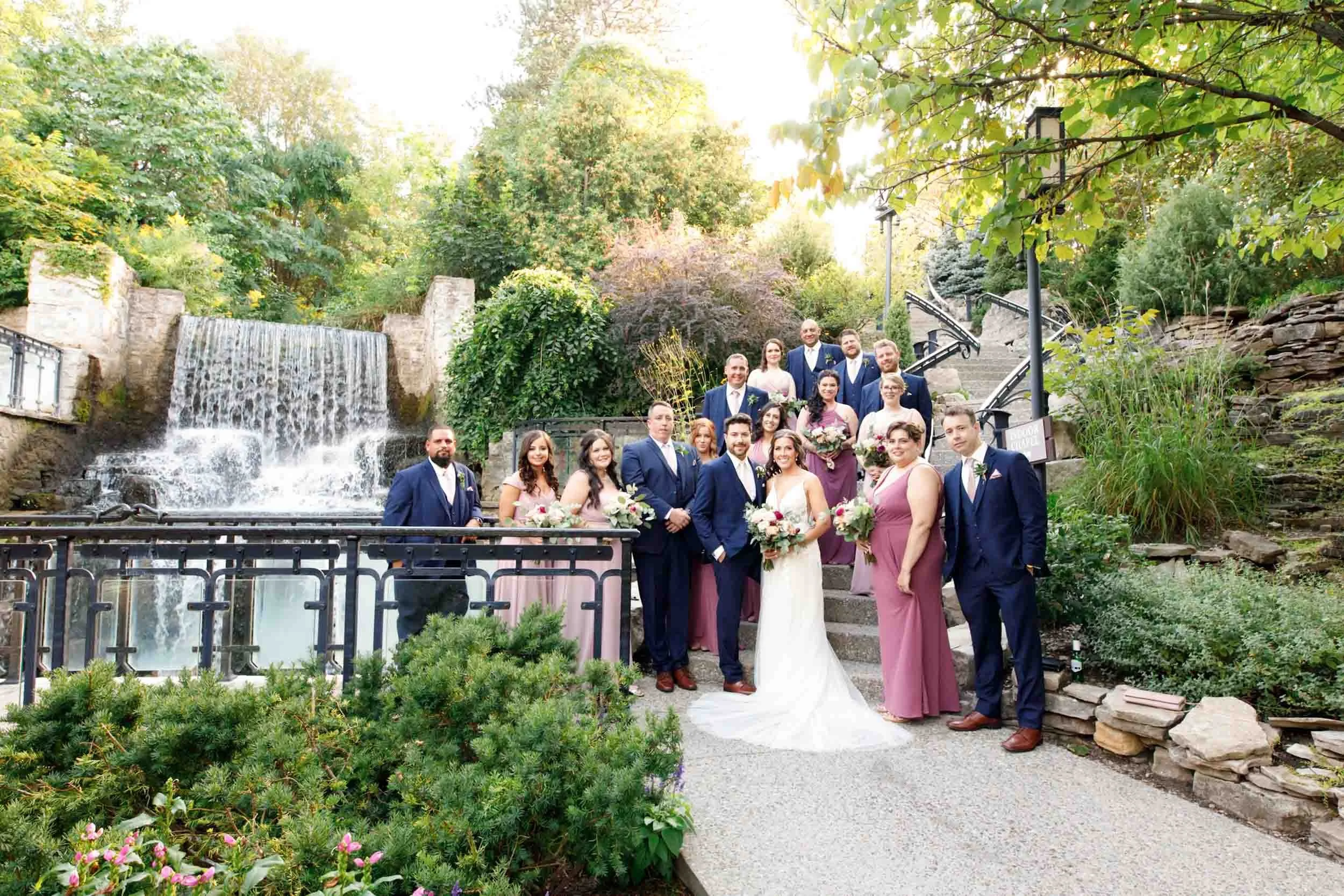 Wedding party portrait with the Ancaster Mill waterfall in Ancaster, Ontario