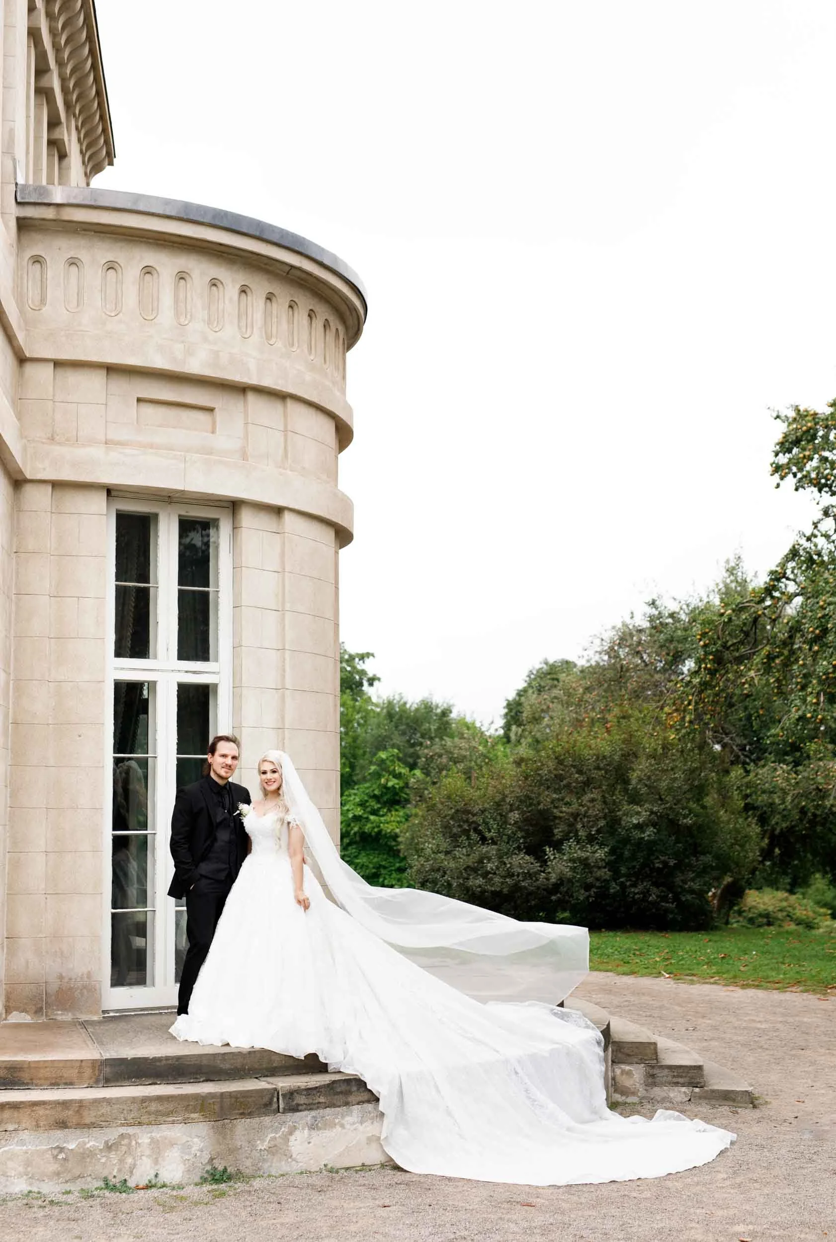 Bride and groom portrait beside Dundurn Castle rounded stone tower