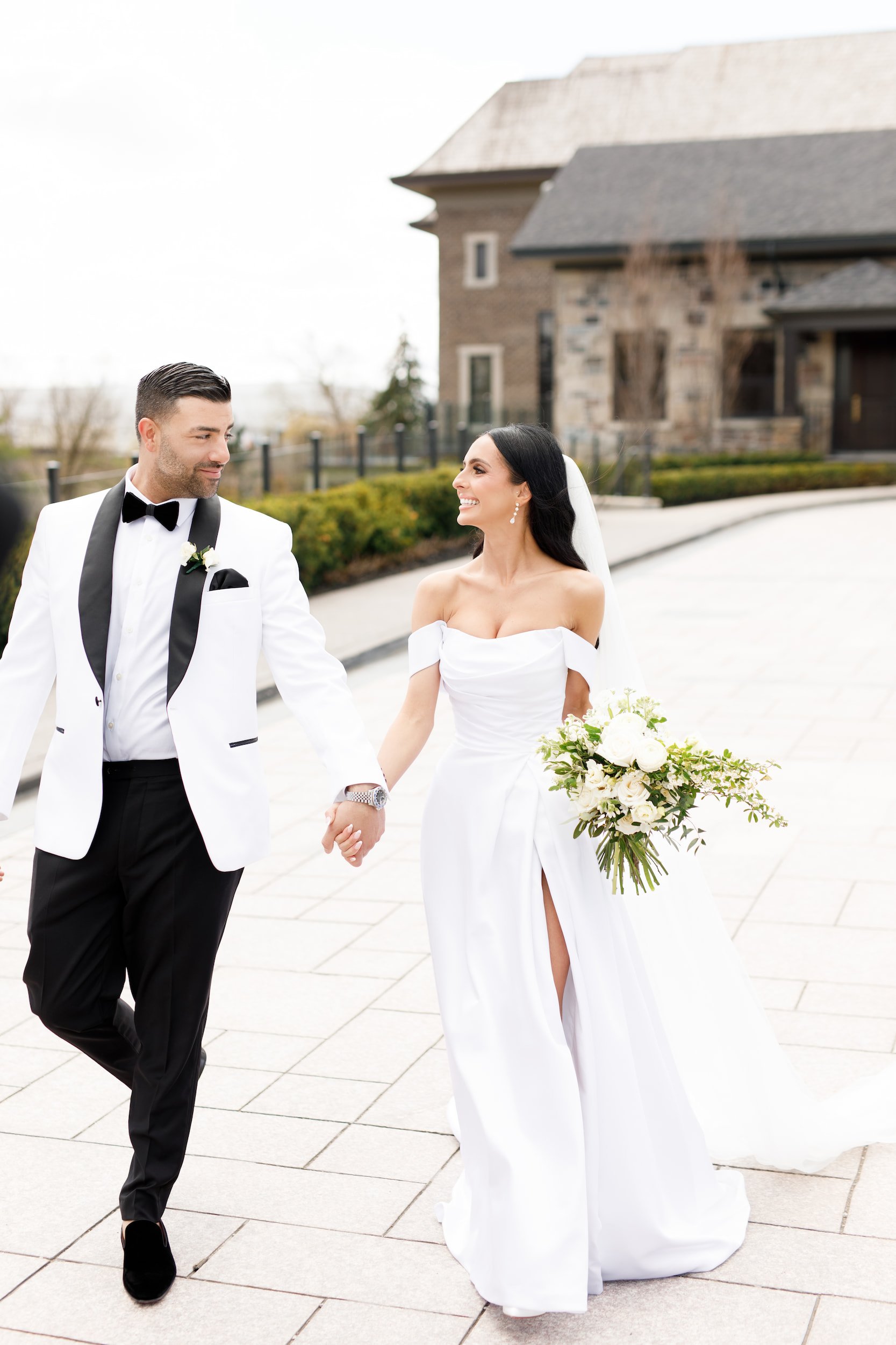 Bride and groom walking through the Arlington Estate courtyard in Vaughan