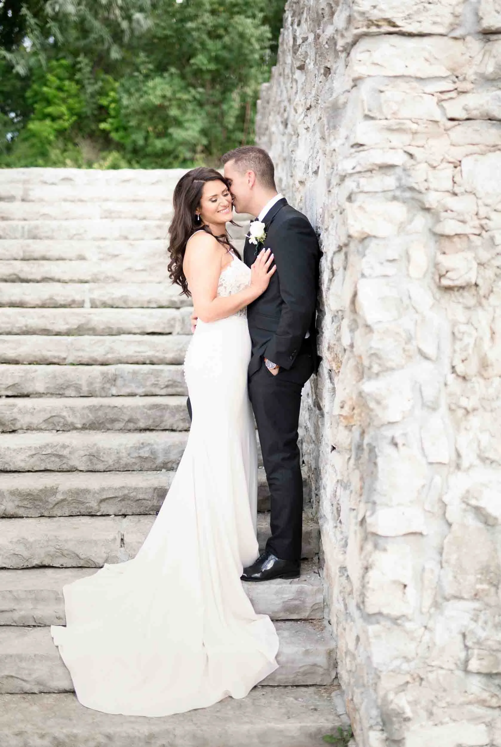 Bride and groom portrait on Mill Race Park limestone staircase at Cambridge Mill in Cambridge, Ontario