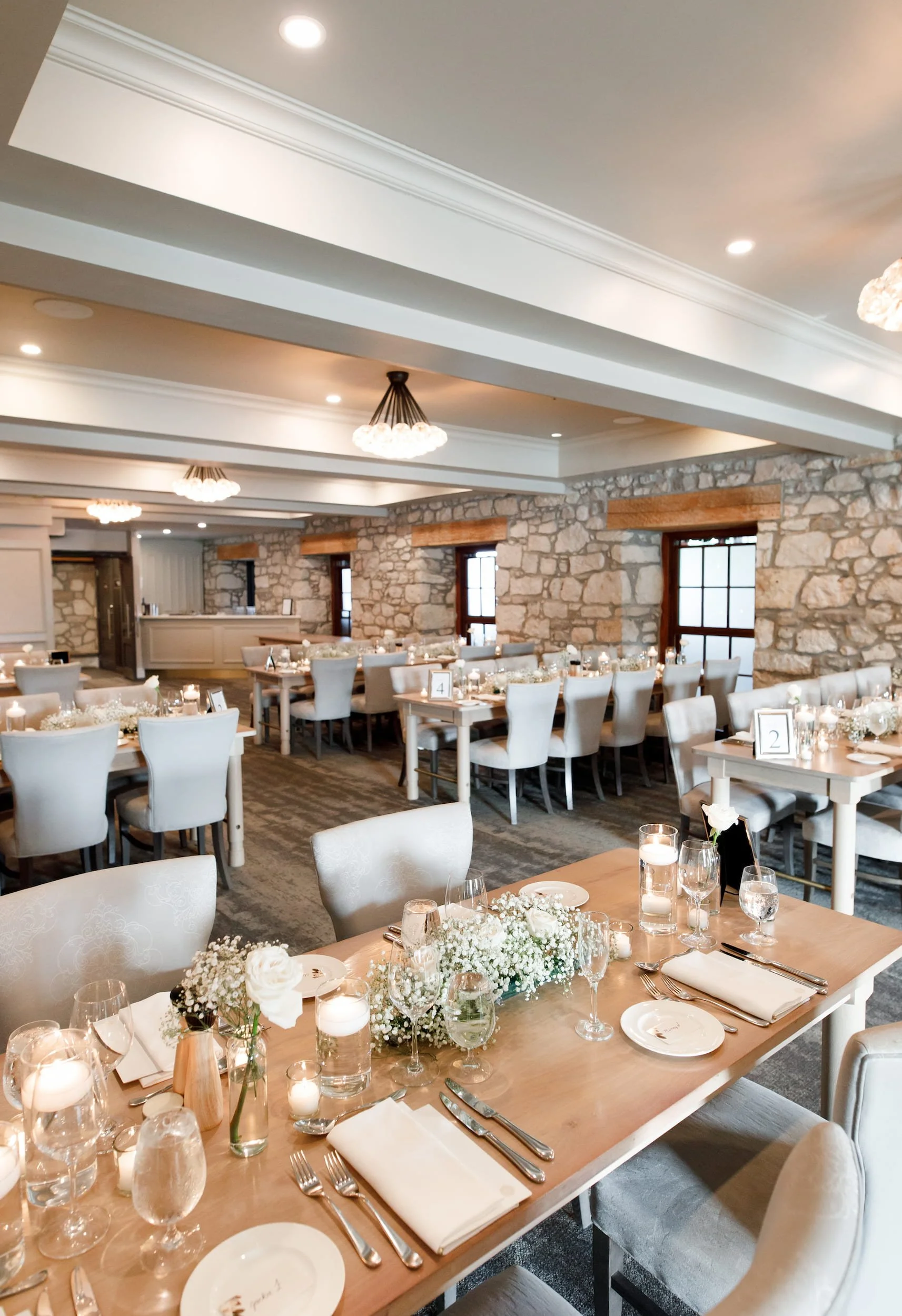 Intimate reception space with historic stone walls at Cambridge Mill wedding venue