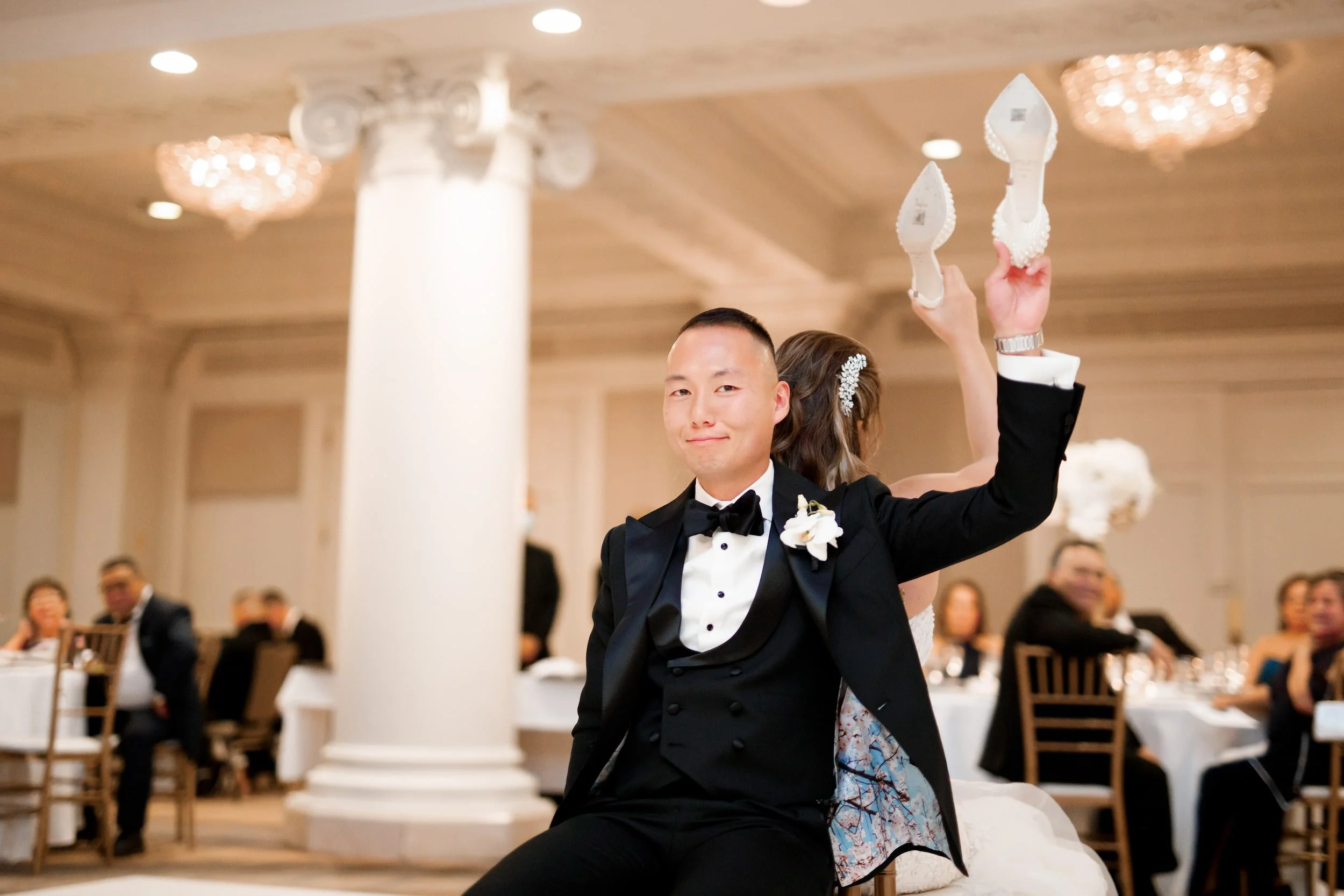 Groom lifted during reception celebration in the Vanity Fair Ballroom