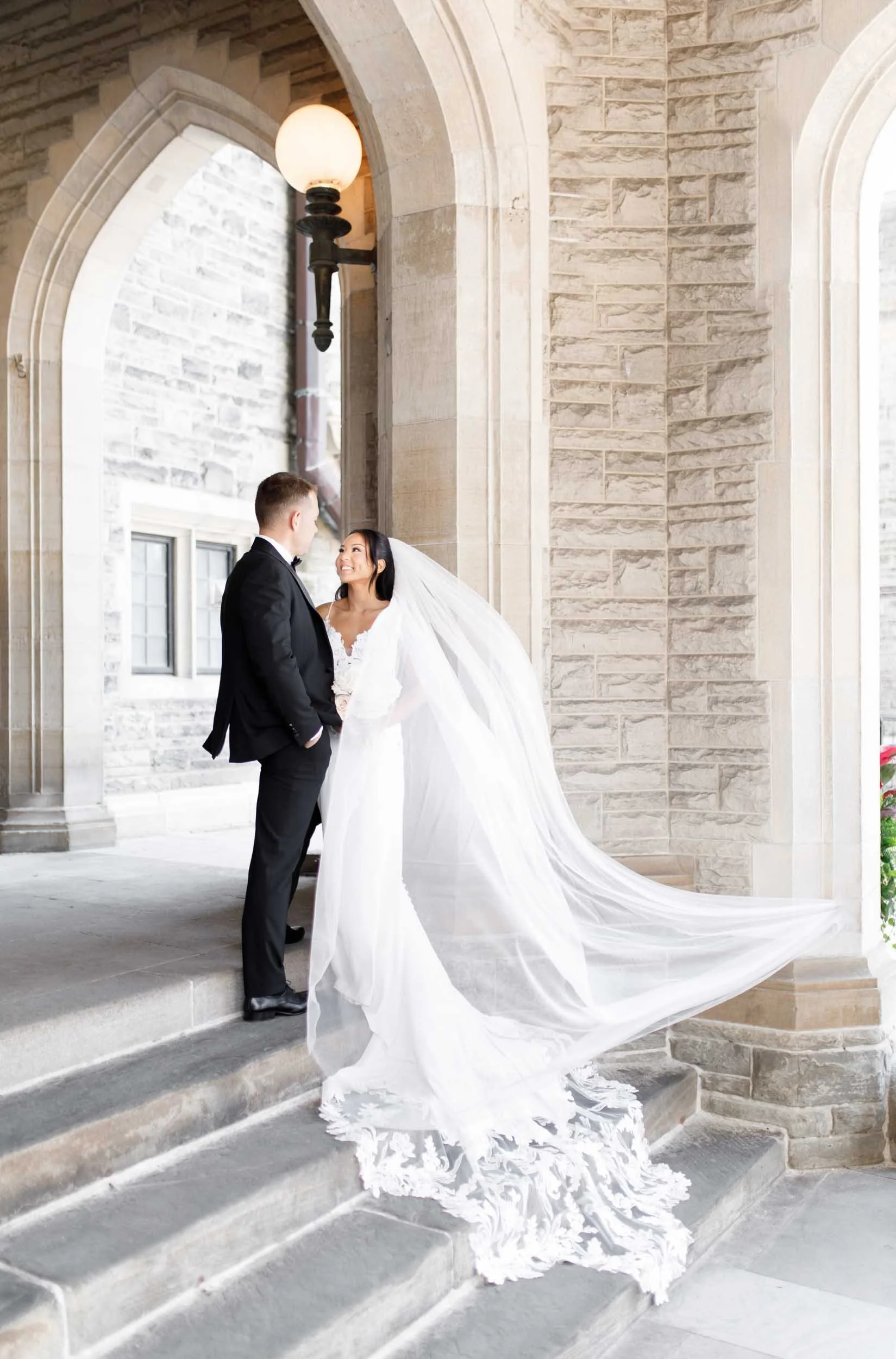 Romantic veil portrait beneath Casa Loma stone archway