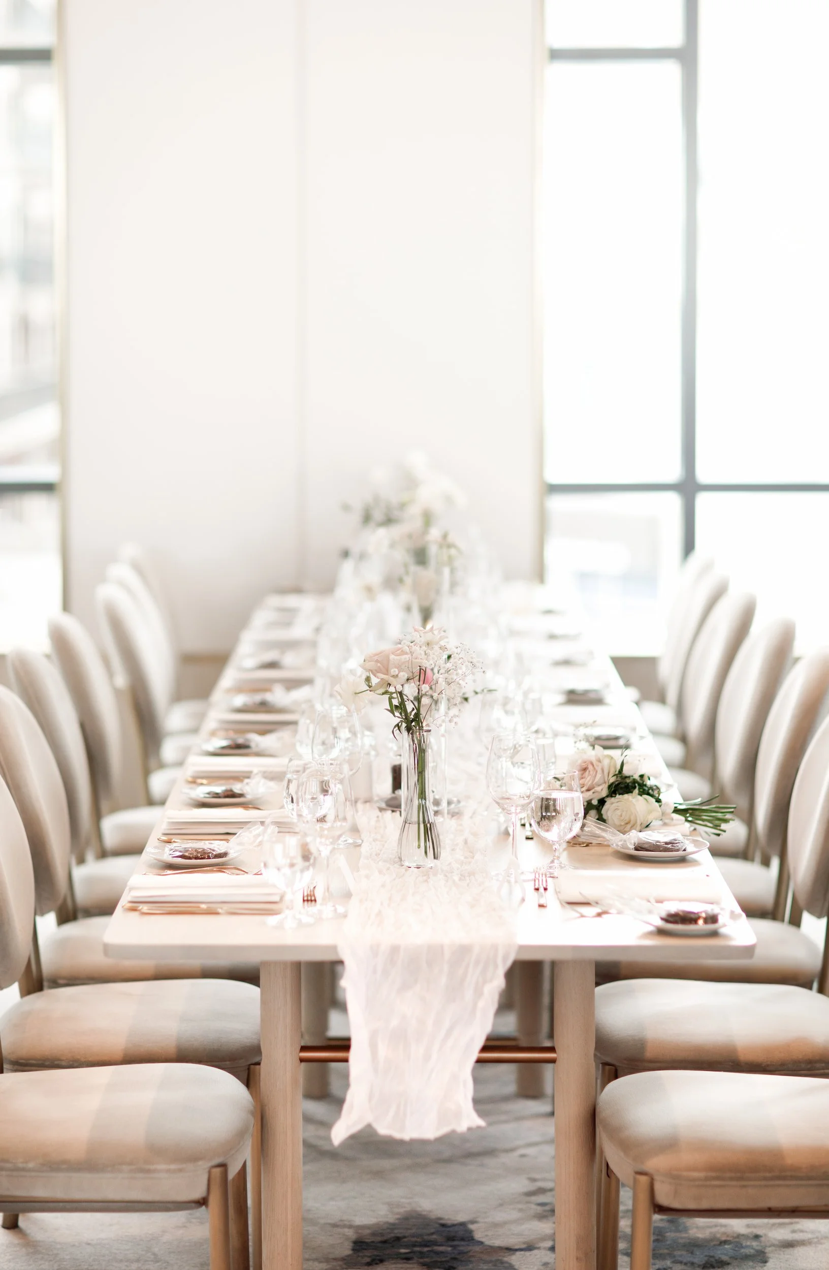 Long reception table with natural light at The Pearle Hotel in Burlington, Ontario