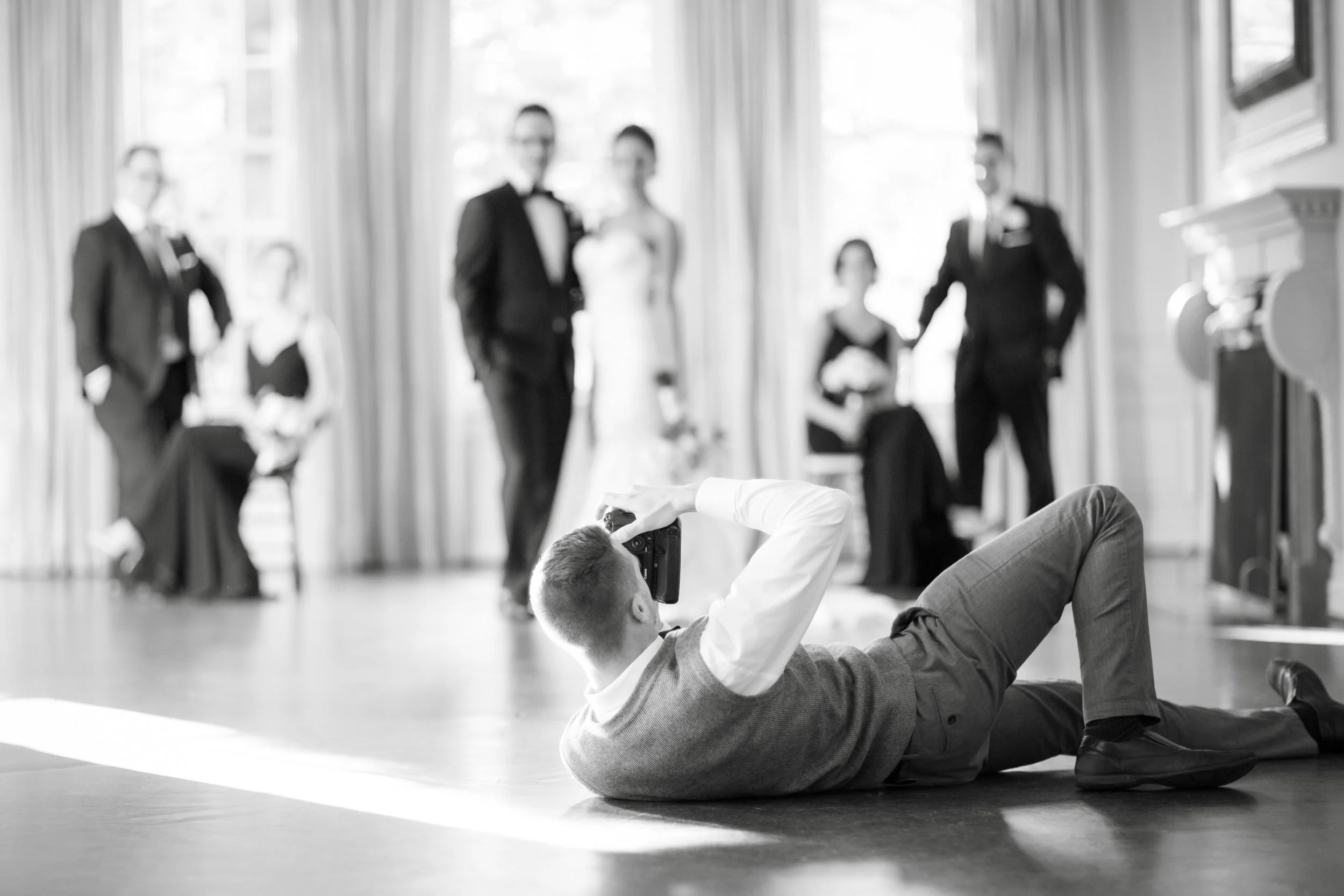 Black and white photo of Toronto wedding photographer Daniel Clements working behind the scenes at Graydon Hall Manor - About Daniel Clements