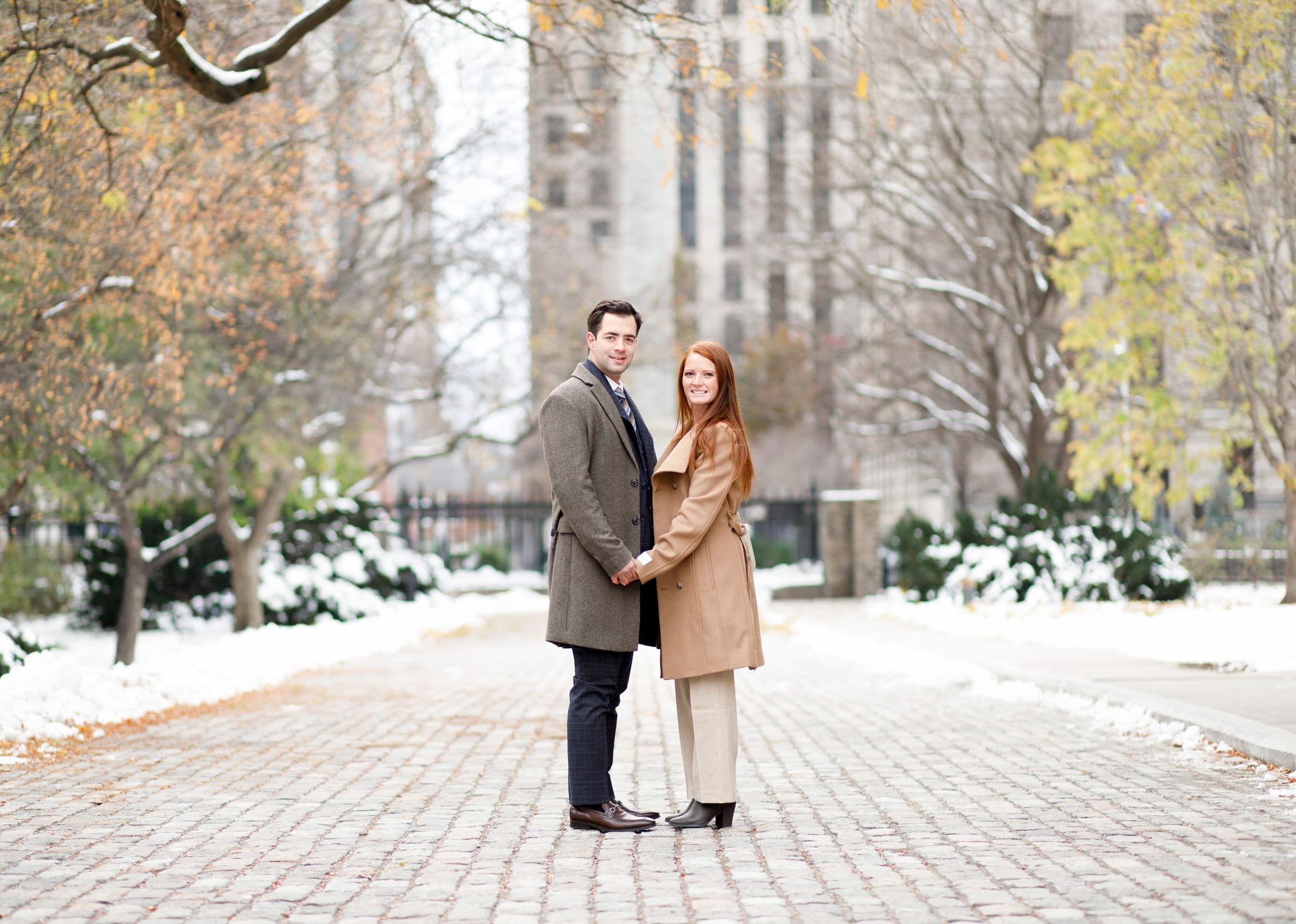 Winter engagement session in snow at Osgoode Hall in downtown Toronto