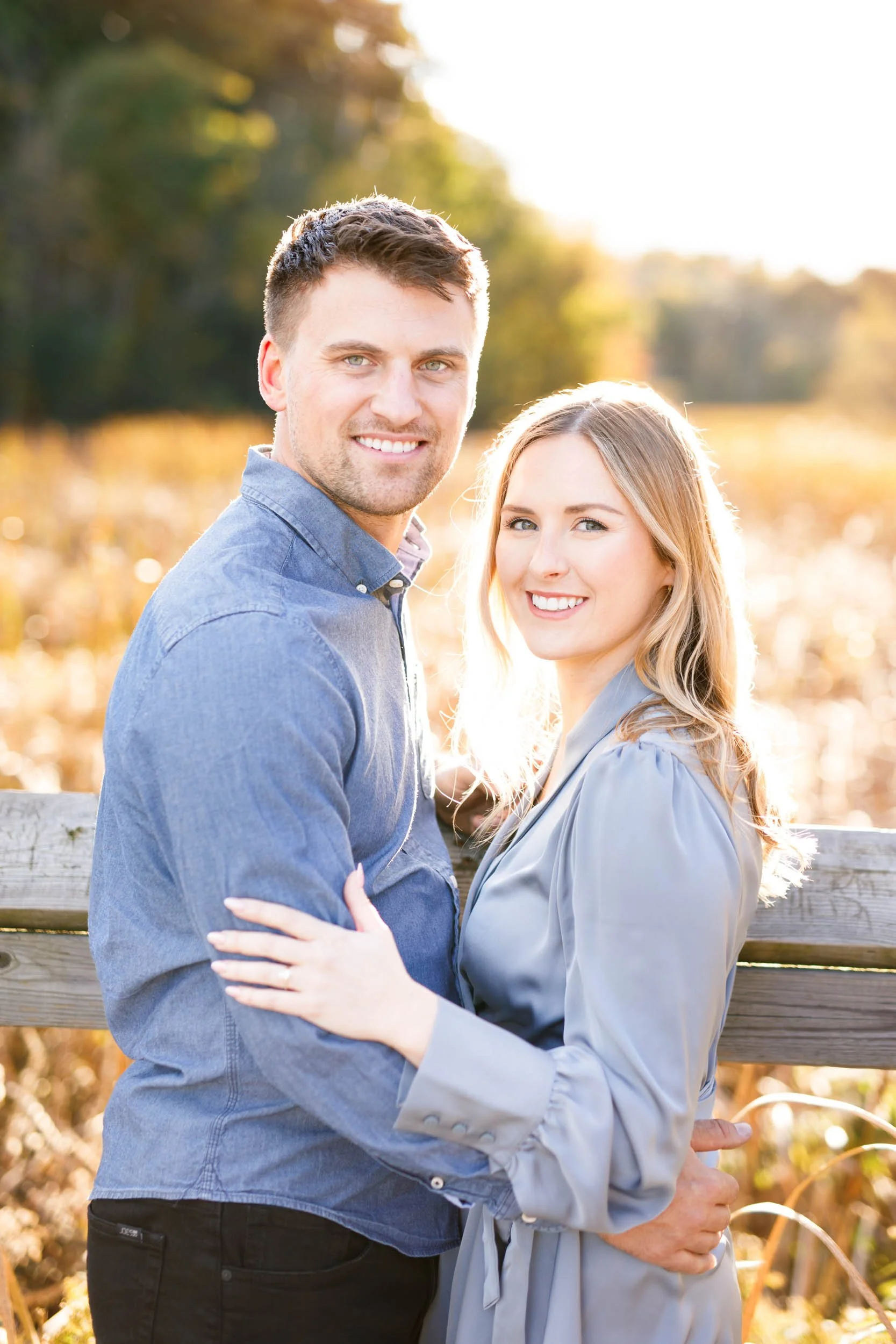 Engagement portrait of a couple standing together on the boardwalk at Grindstone Marsh Trail in Burlington Ontario