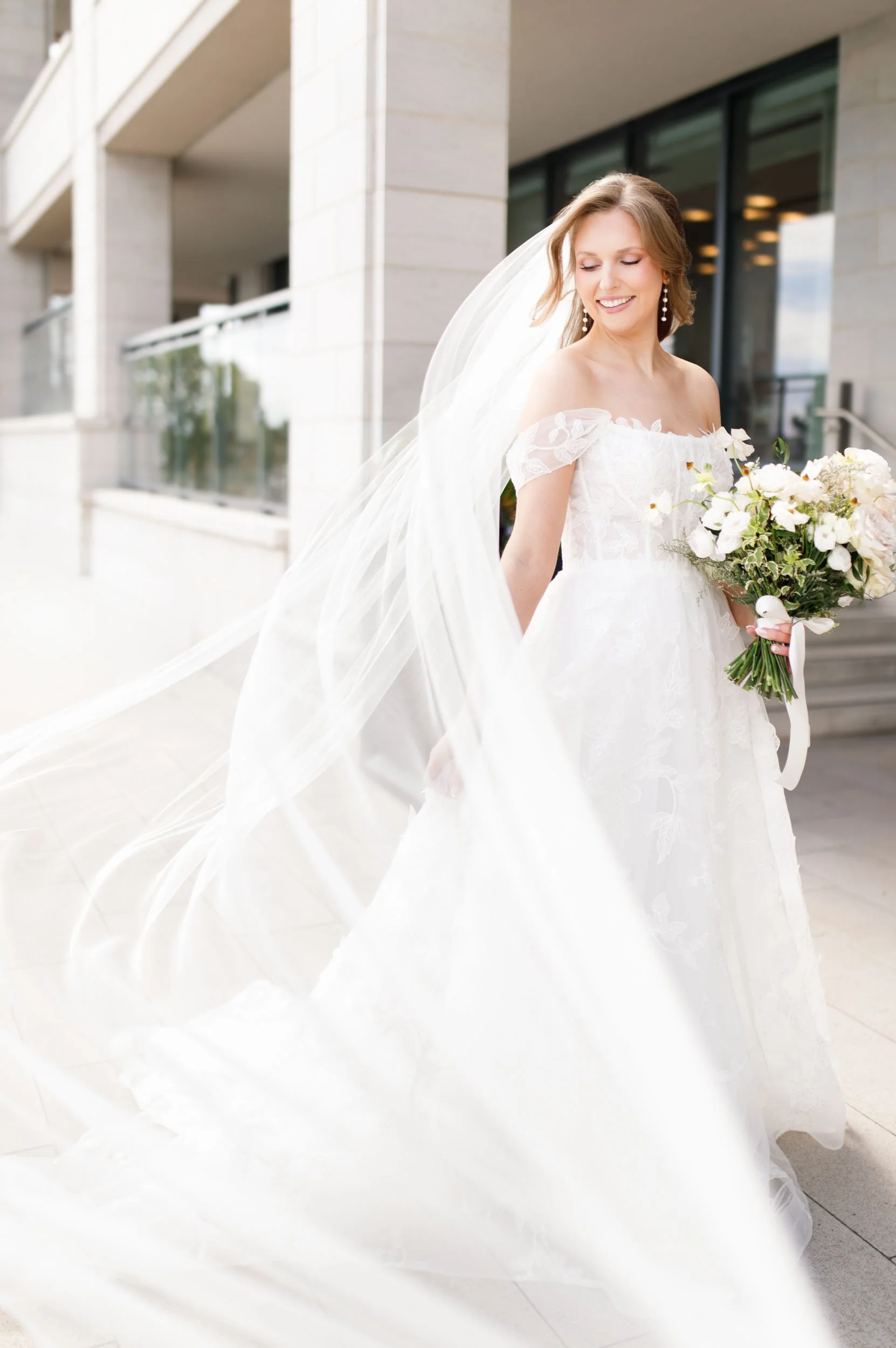 Bride walking with her veil flowing at the Pearle Hotel in Burlington