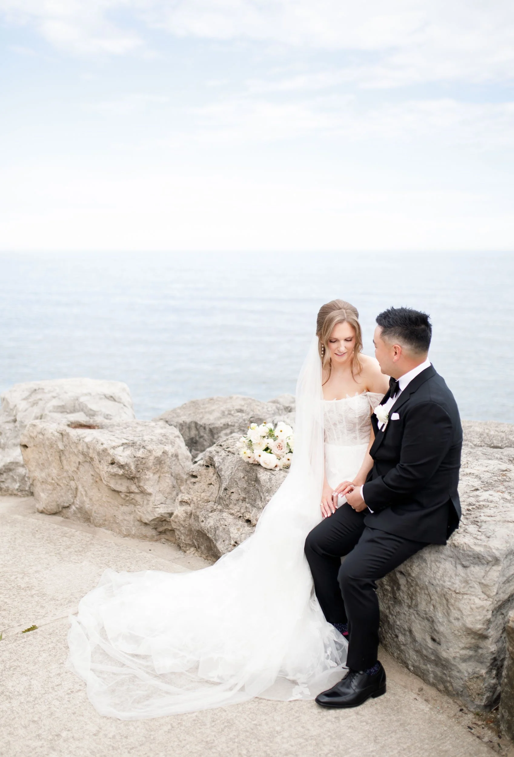 Bride and groom on the lakeshore at the Pearle Hotel in Burlington
