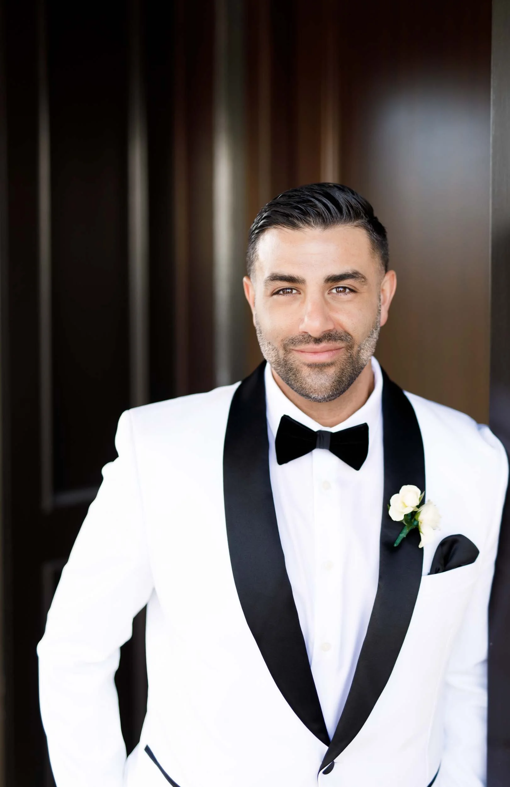 Groom portrait in a white tuxedo at the Arlington Estate in Vaughan