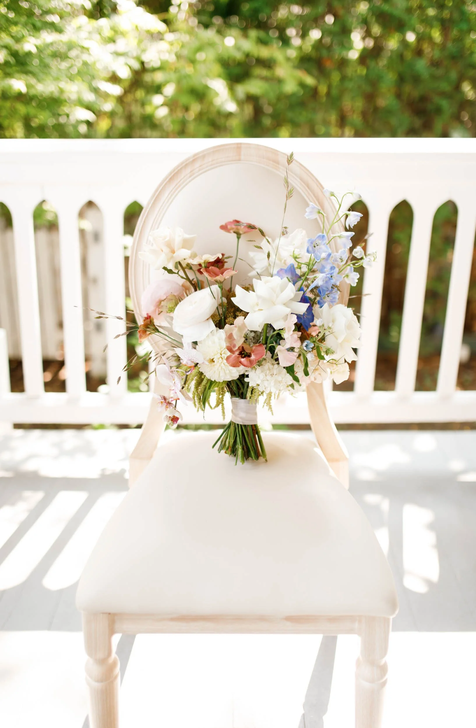 Outdoor wedding ceremony chair with floral arrangement at The Doctor’s House in Kleinburg