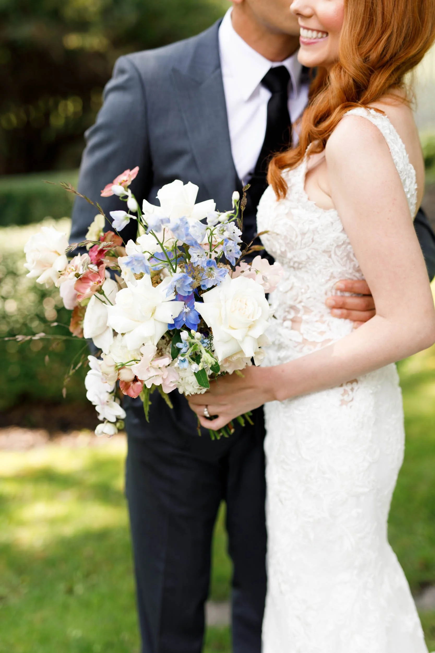 Wedding bouquet held by bride and groom at The Doctor’s House in Kleinburg