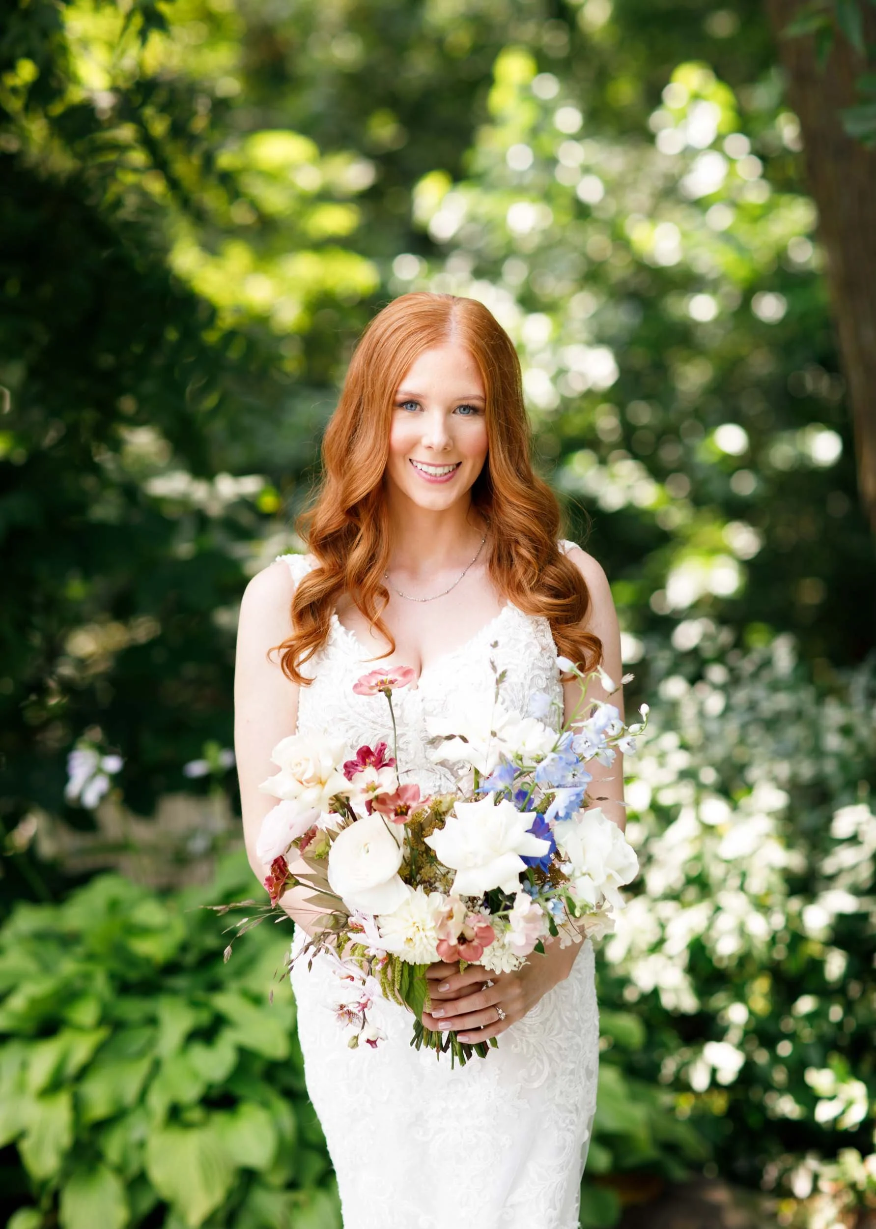 Bride holding bouquet in sun-drenched garden at The Doctor’s House in Kleinburg