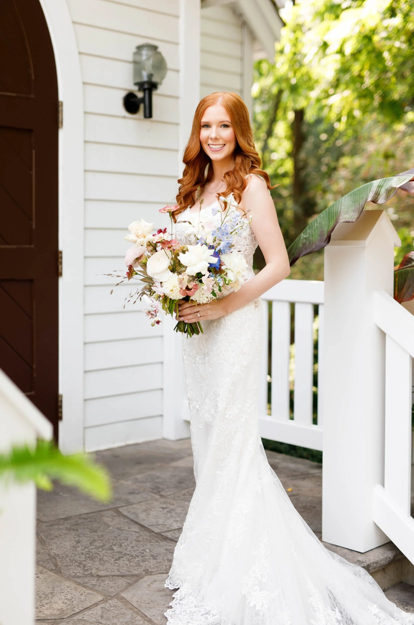 Bride on the porch at The Doctor’s House in Kleinburg, Ontario summer wedding