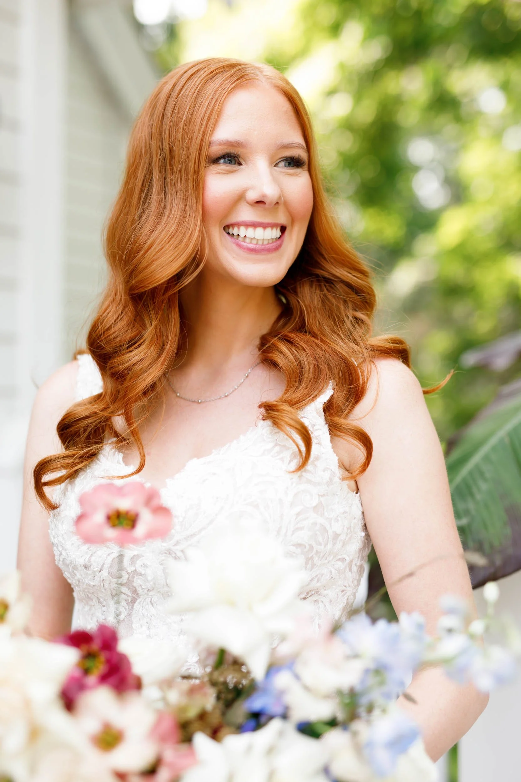 Bride smiling with bouquet at The Doctor’s House in Kleinburg, Ontario