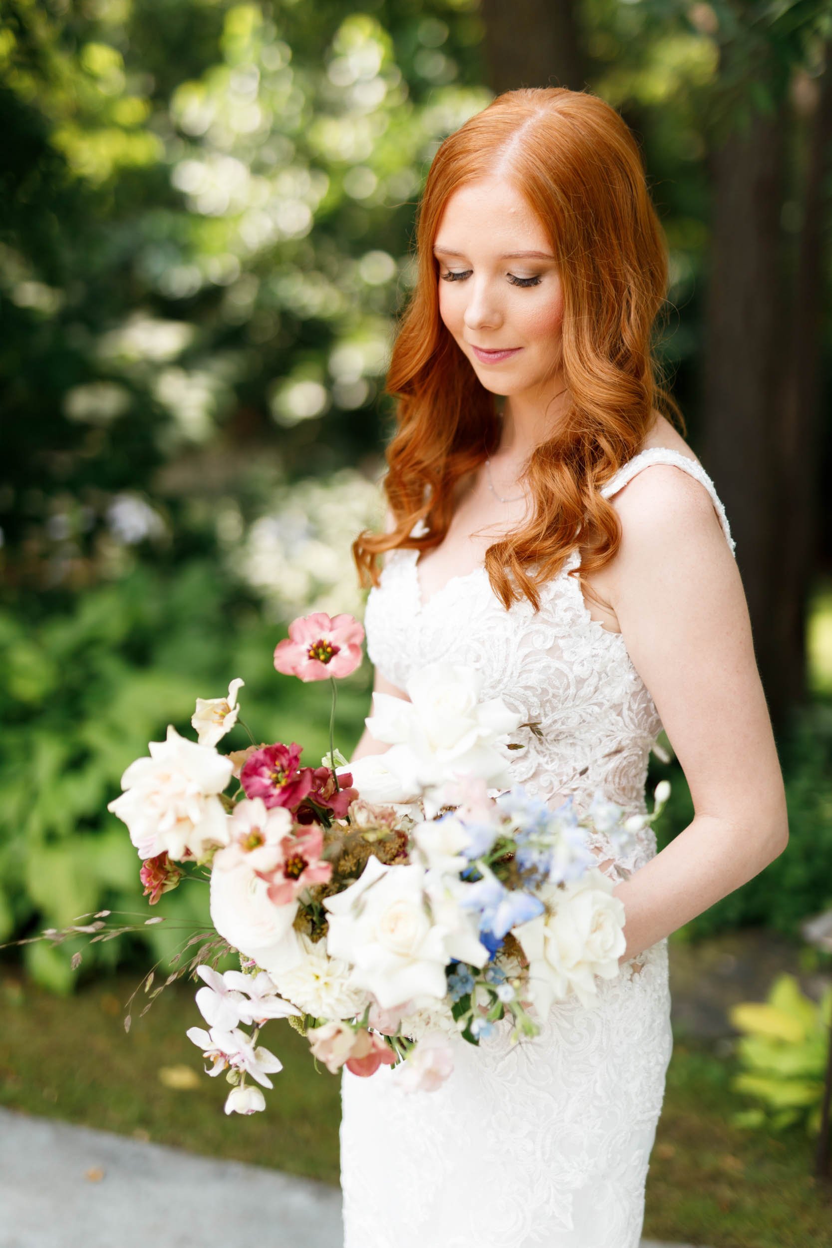 Bride holding bouquet outdoors at The Doctor’s House in Kleinburg, Ontario