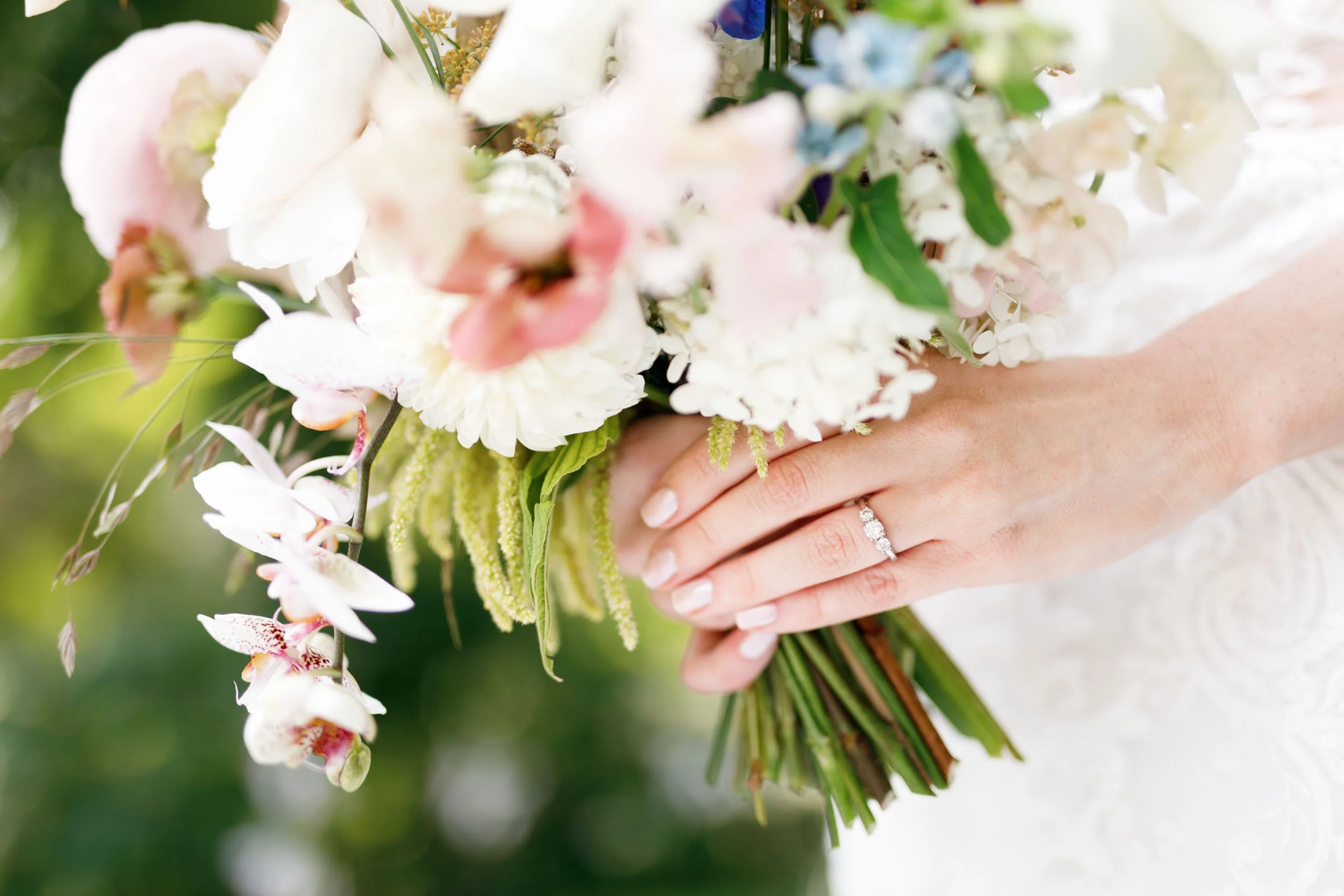 Close-up bride holding bouquet with wedding ring at The Doctor’s House in Kleinburg