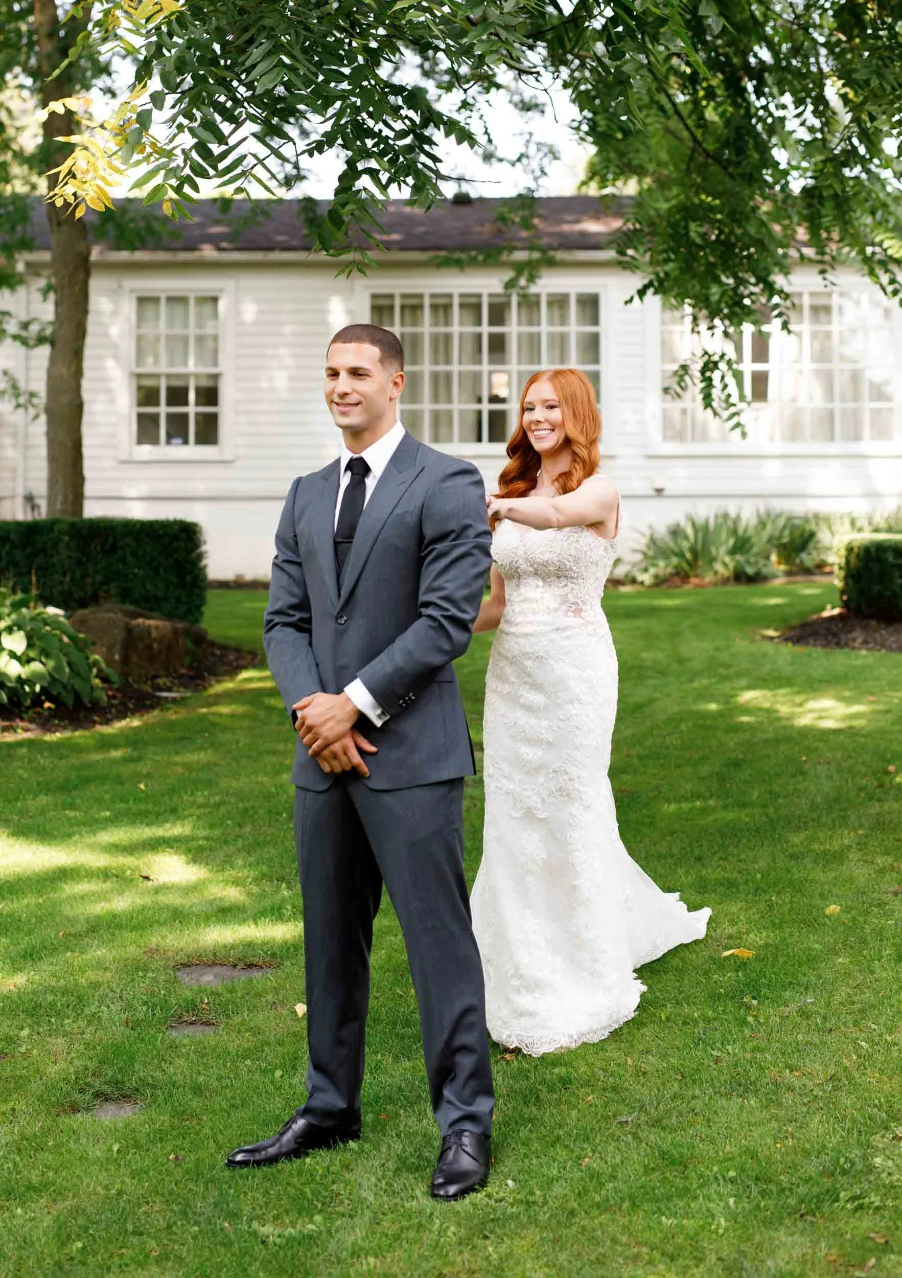 Bride and groom standing before first look at The Doctor’s House in Kleinburg, Ontario
