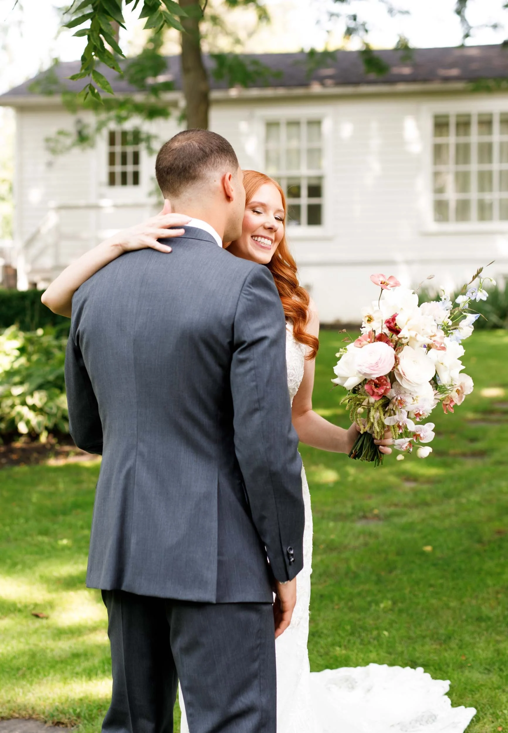 Groom and bride smiling during first look at The Doctor’s House in Kleinburg, Ontario