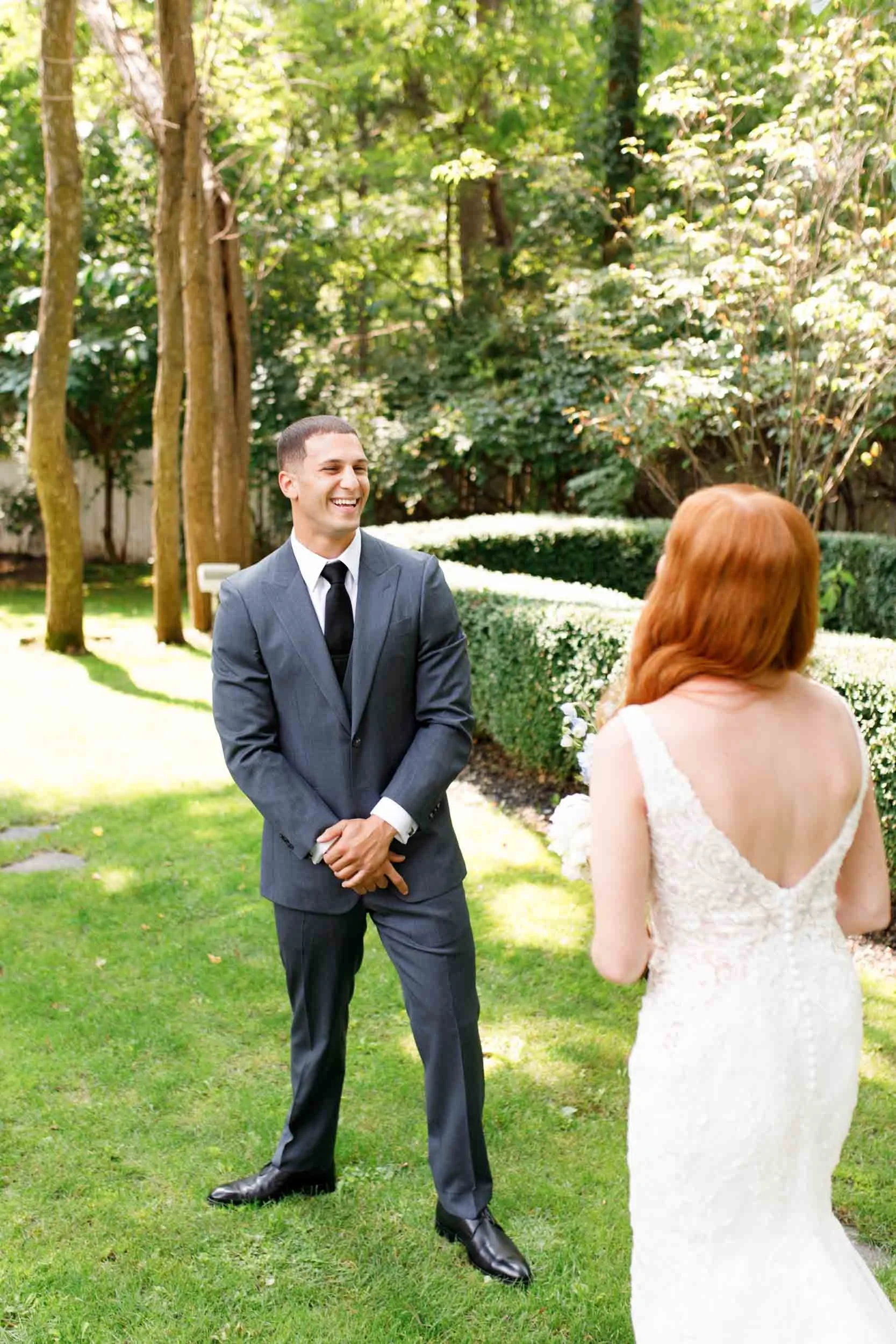 Groom turning to see bride during first look at The Doctor’s House in Kleinburg