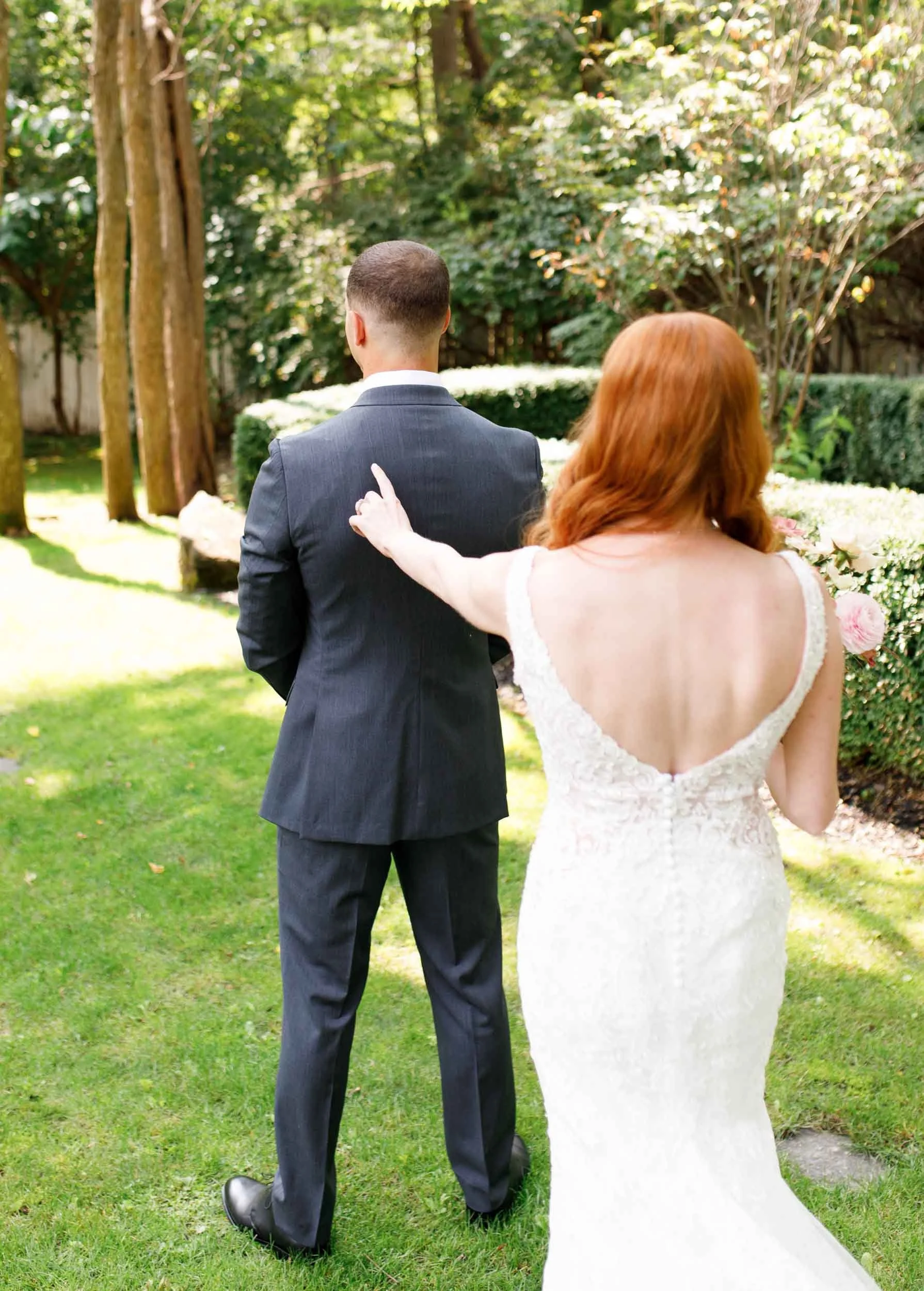 Bride approaching groom from behind at The Doctor’s House in Kleinburg wedding