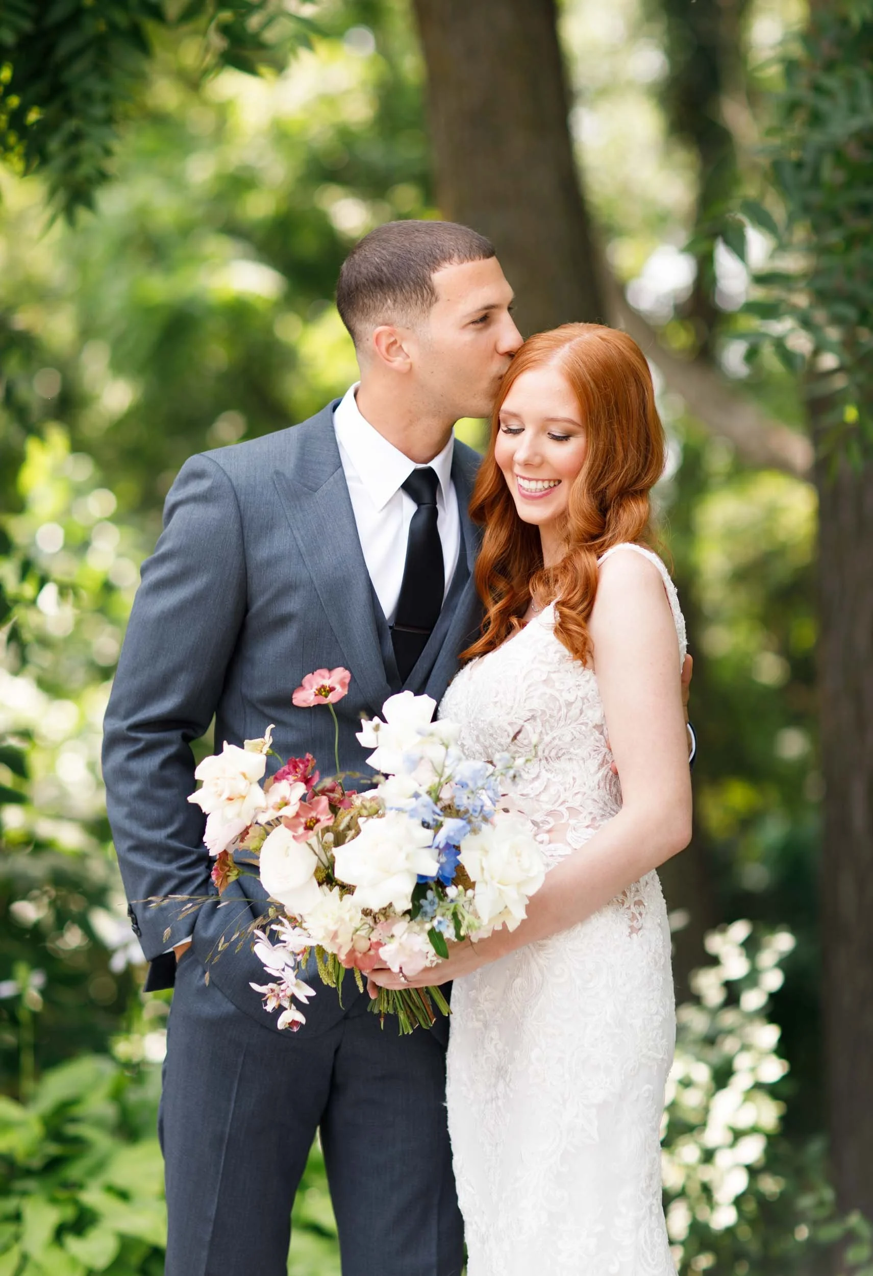 Bride and groom holding bouquet at The Doctor’s House in Kleinburg wedding