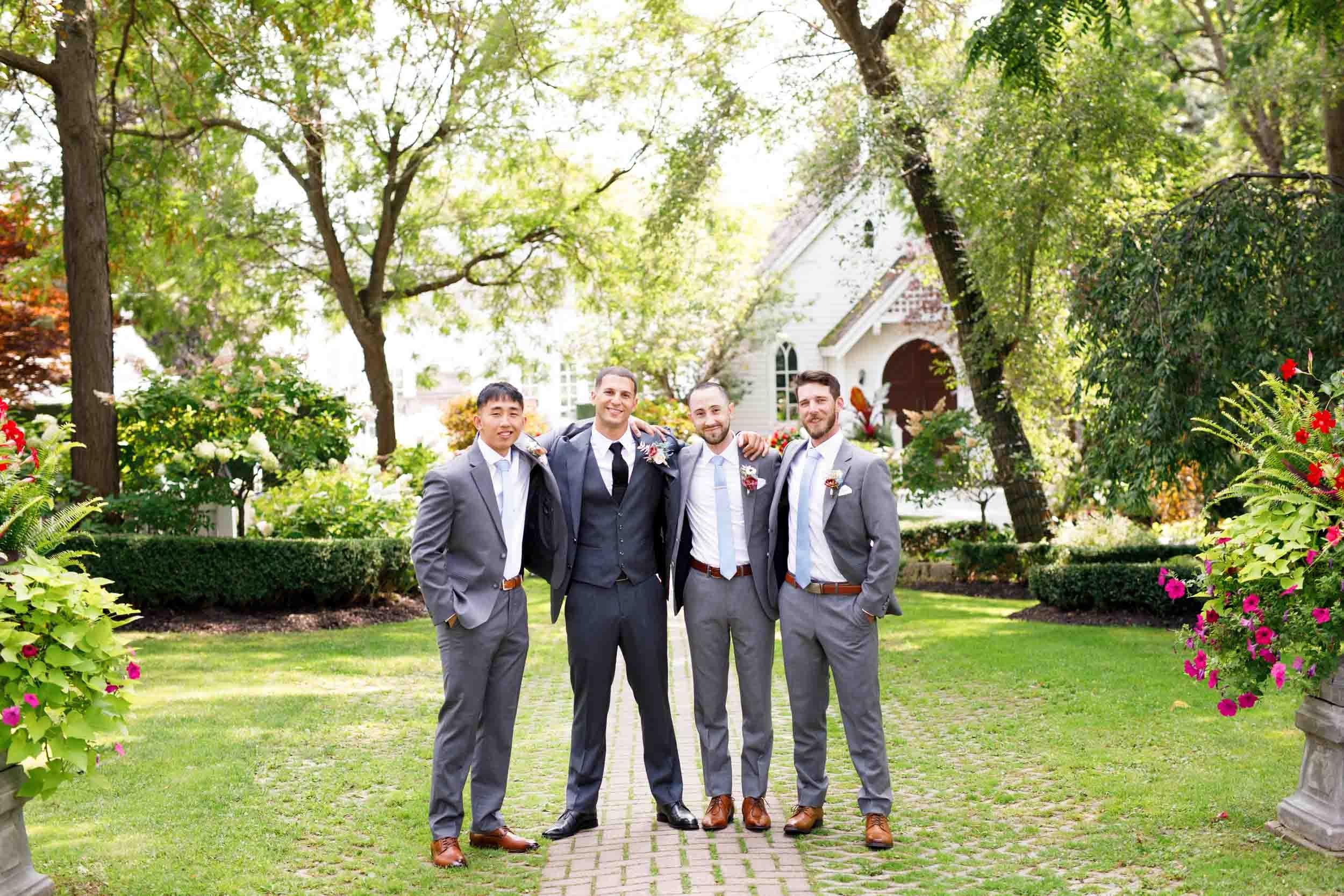 Groomsmen standing together at The Doctor’s House in Kleinburg, Ontario