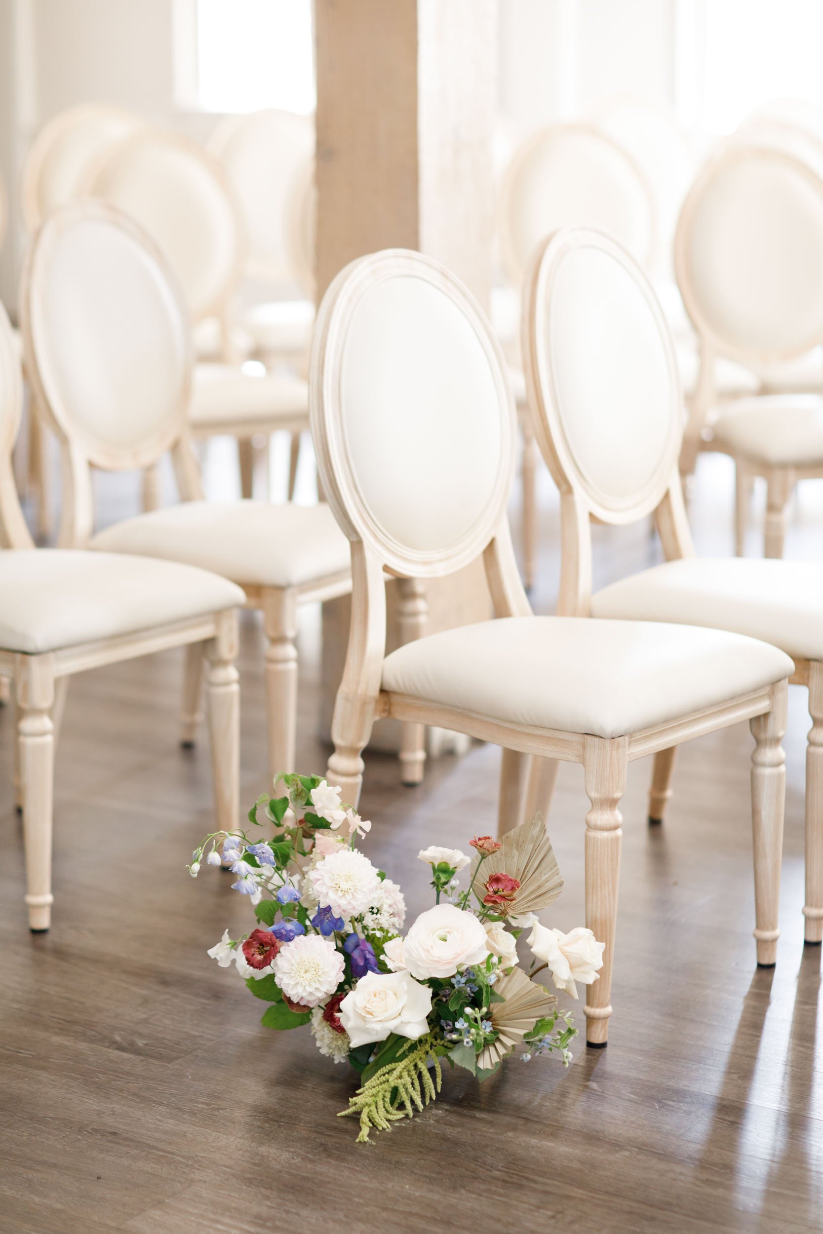Wedding ceremony chairs with florals at The Doctor’s House in Kleinburg, Ontario