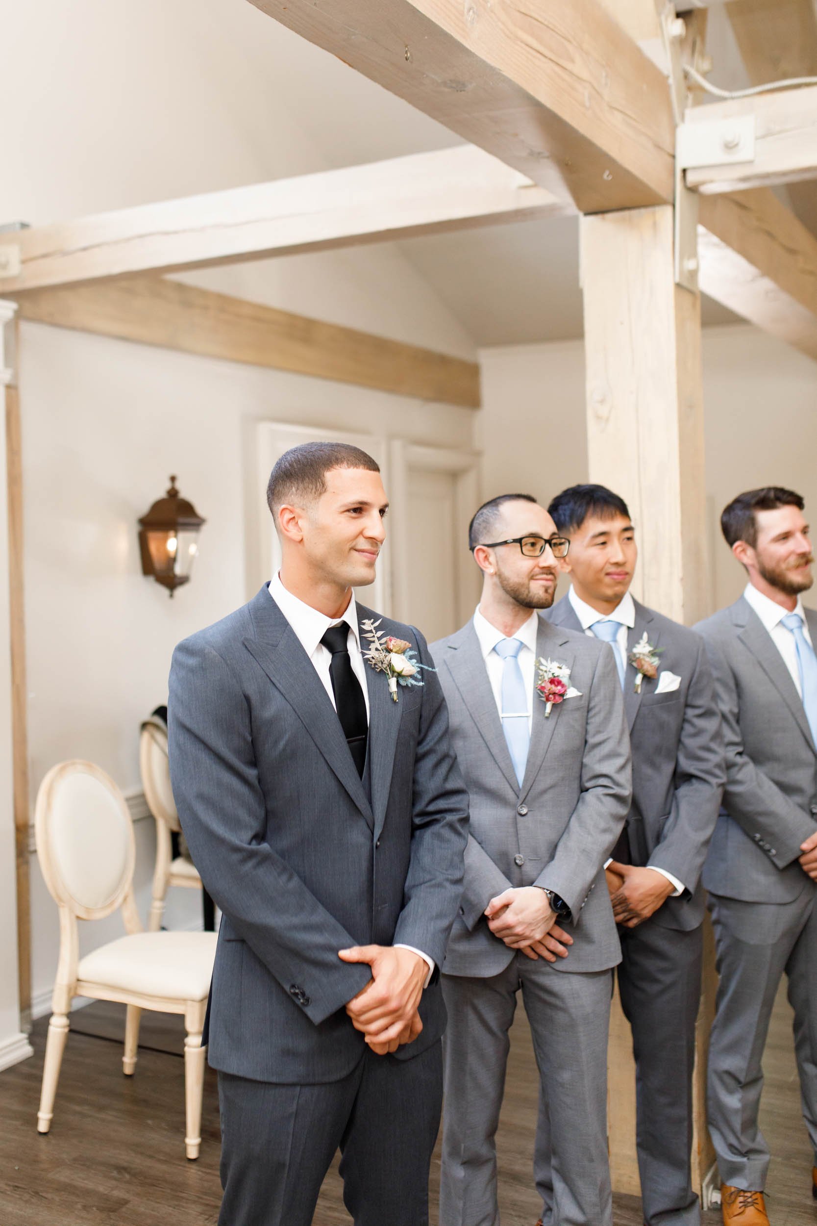 Groomsmen standing during ceremony at The Doctor’s House in Kleinburg