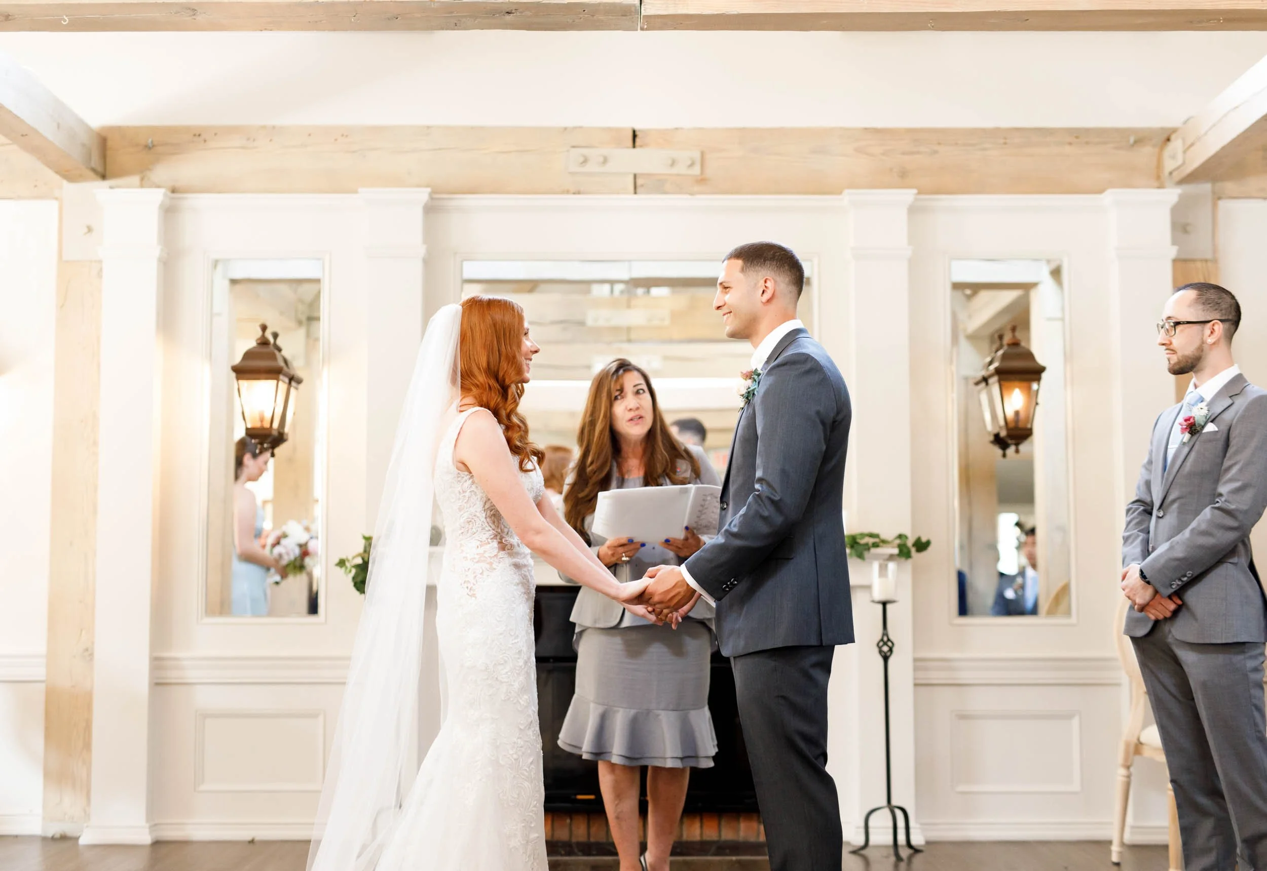 Bride and groom holding hands at altar at The Doctor’s House in Kleinburg, Ontario