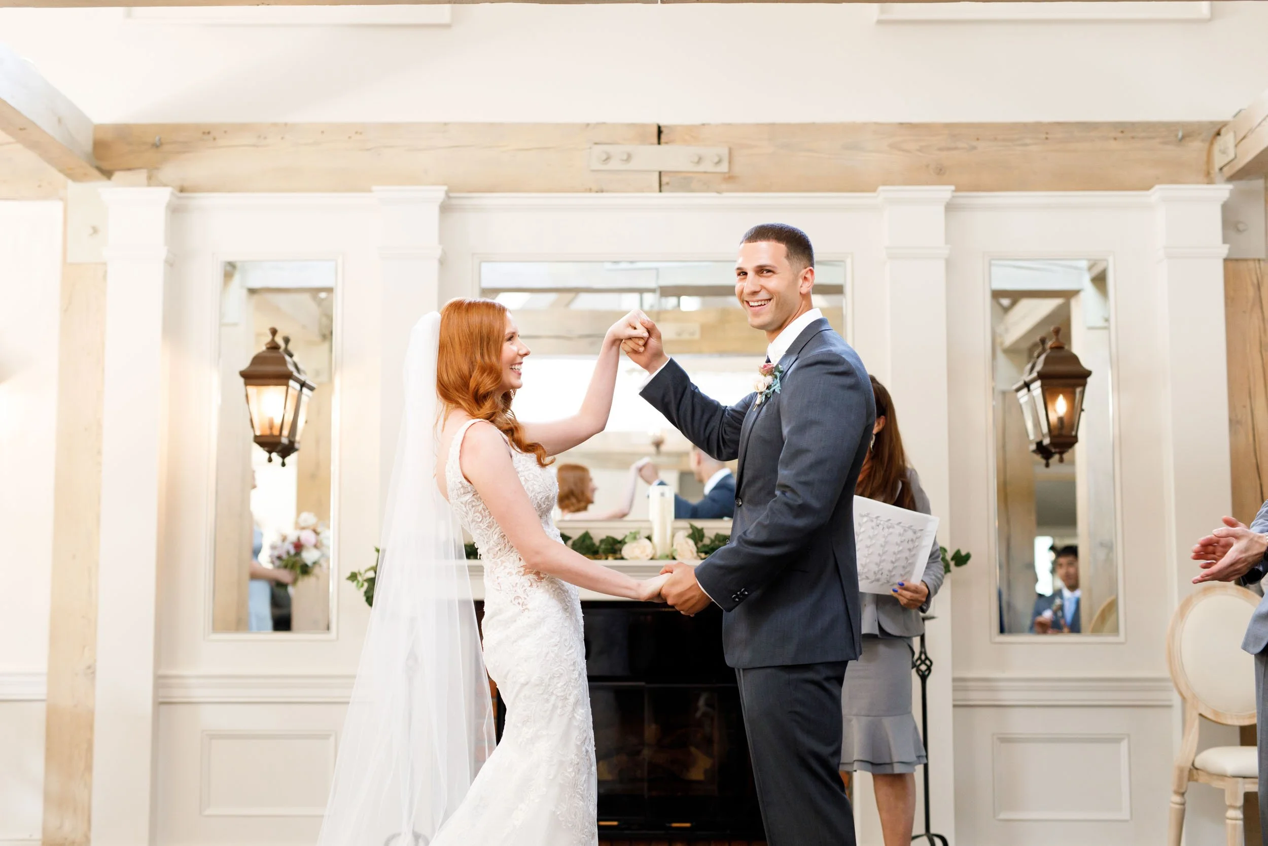 Bride and groom holding hands at altar at The Doctor’s House in Kleinburg, Ontario