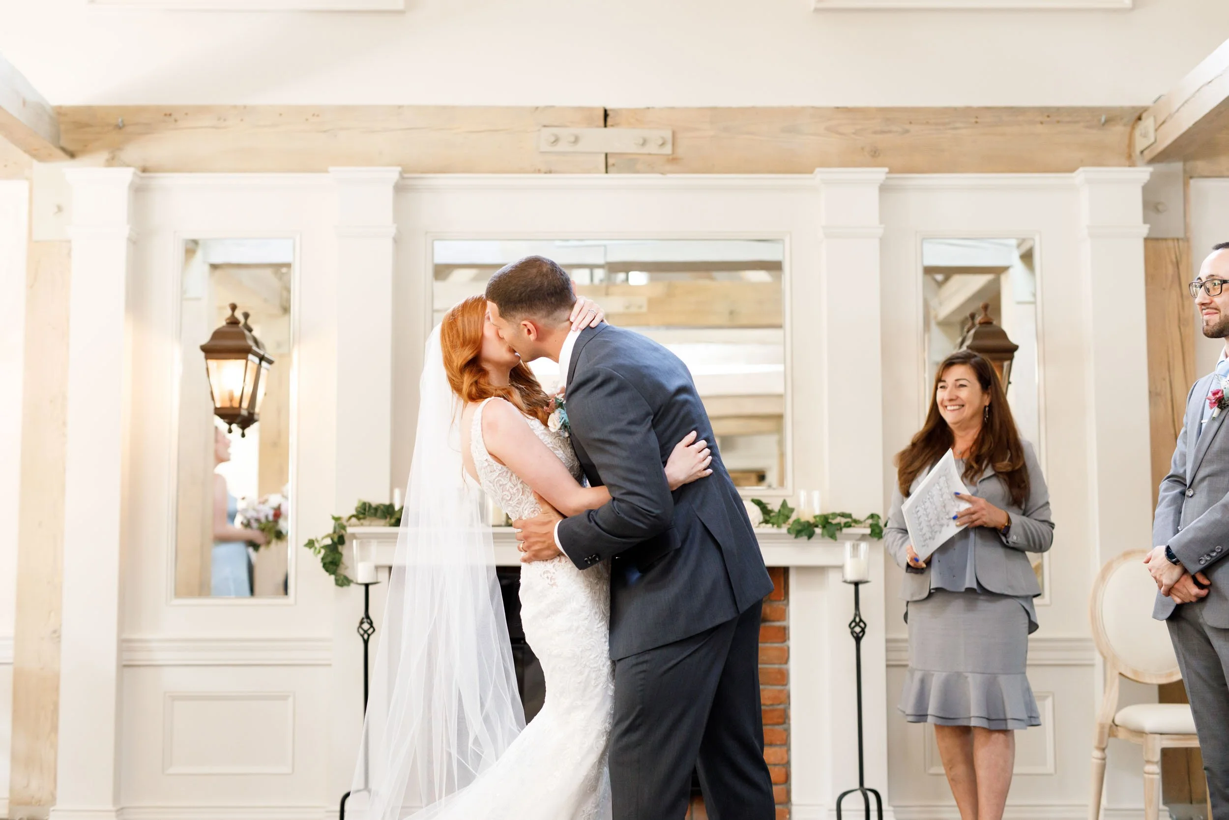 Newlyweds kissing during ceremony at The Doctor’s House in Kleinburg, Ontario
