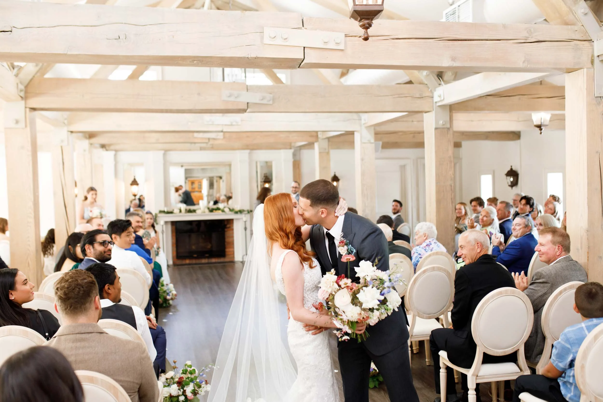 Bride and groom kissing during recessional at The Doctor’s House in Kleinburg