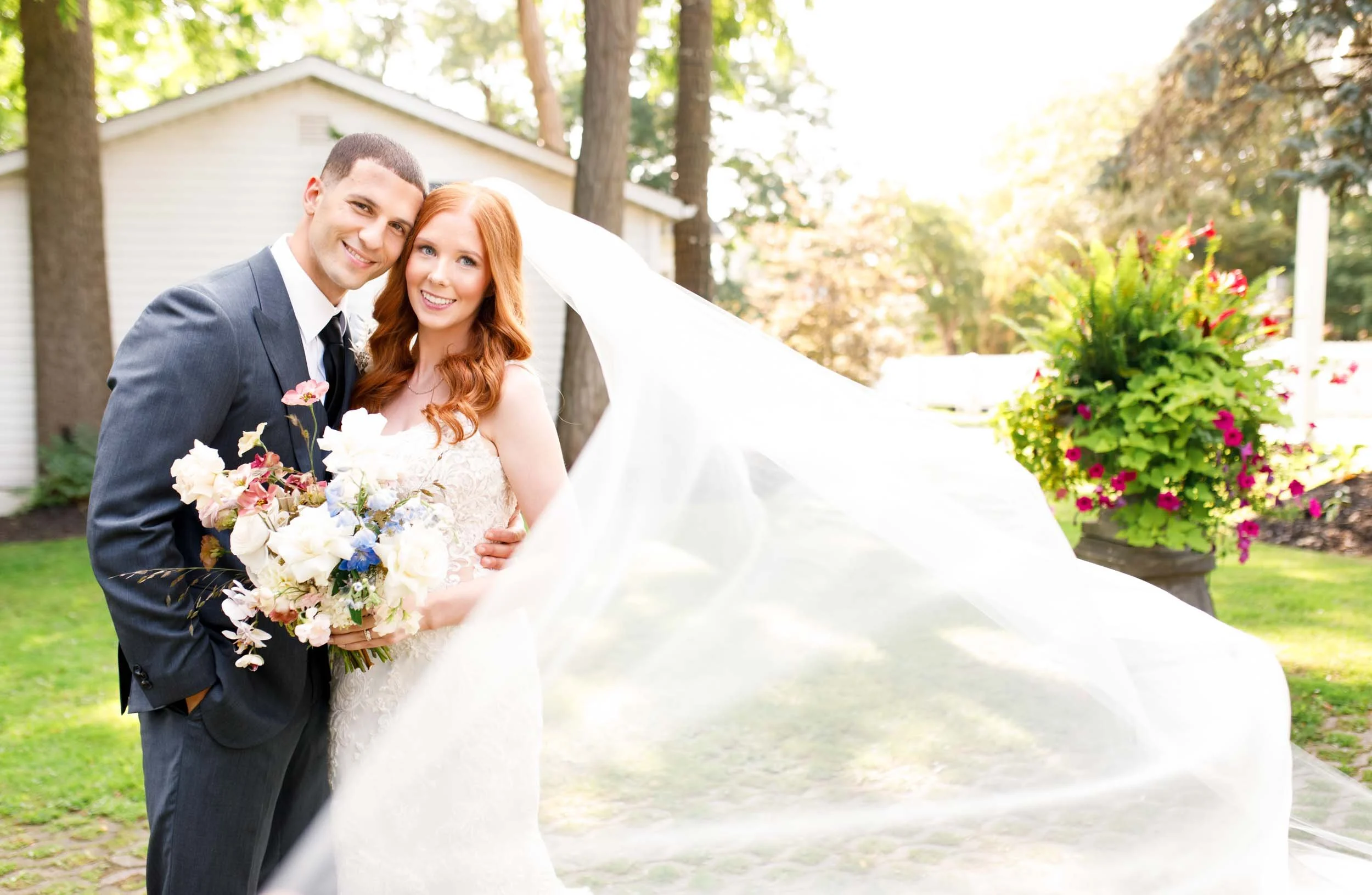 Bride and groom with flowing veil at The Doctor’s House in Kleinburg, Ontario wedding