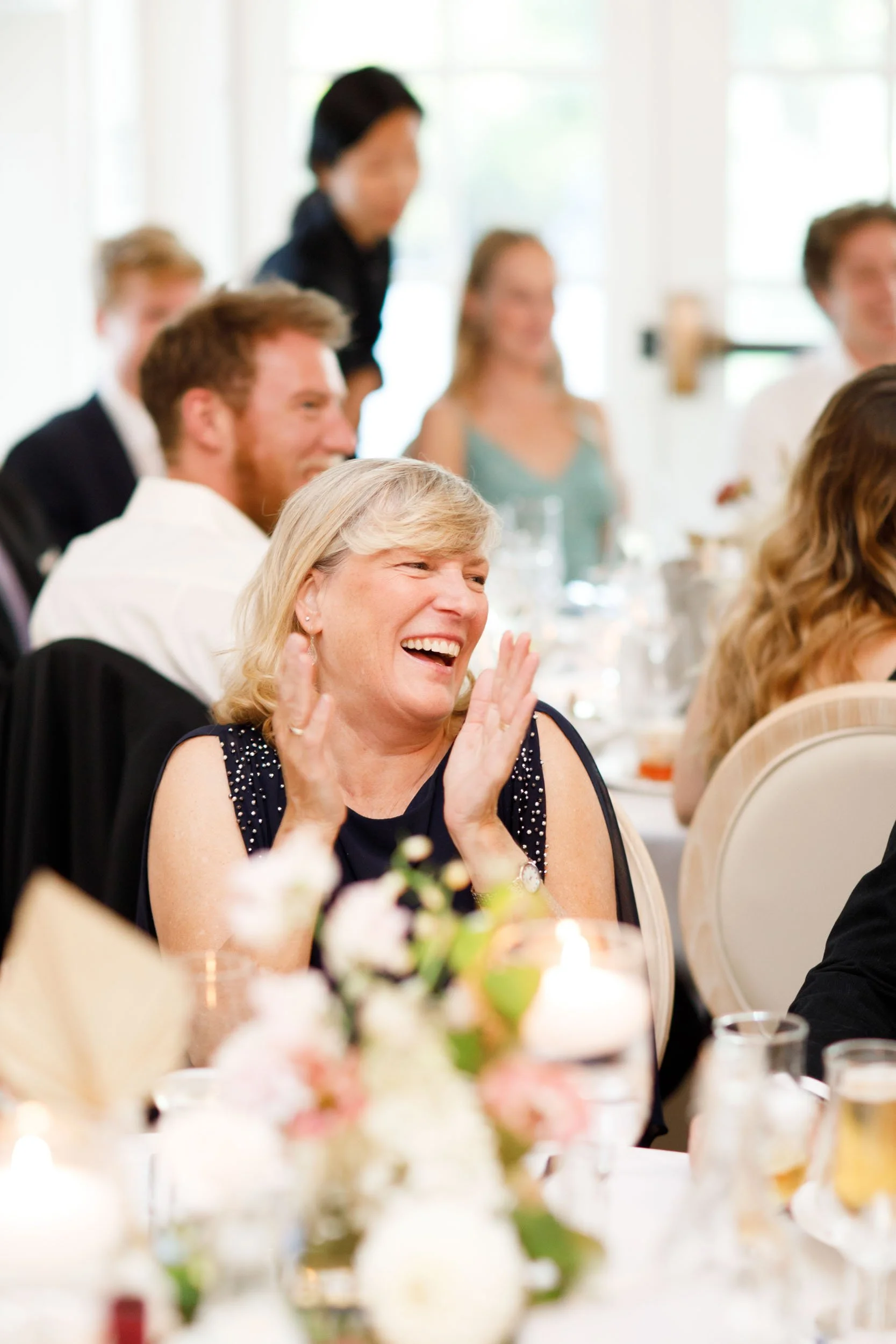Wedding guests laughing during speeches at The Doctor’s House in Kleinburg