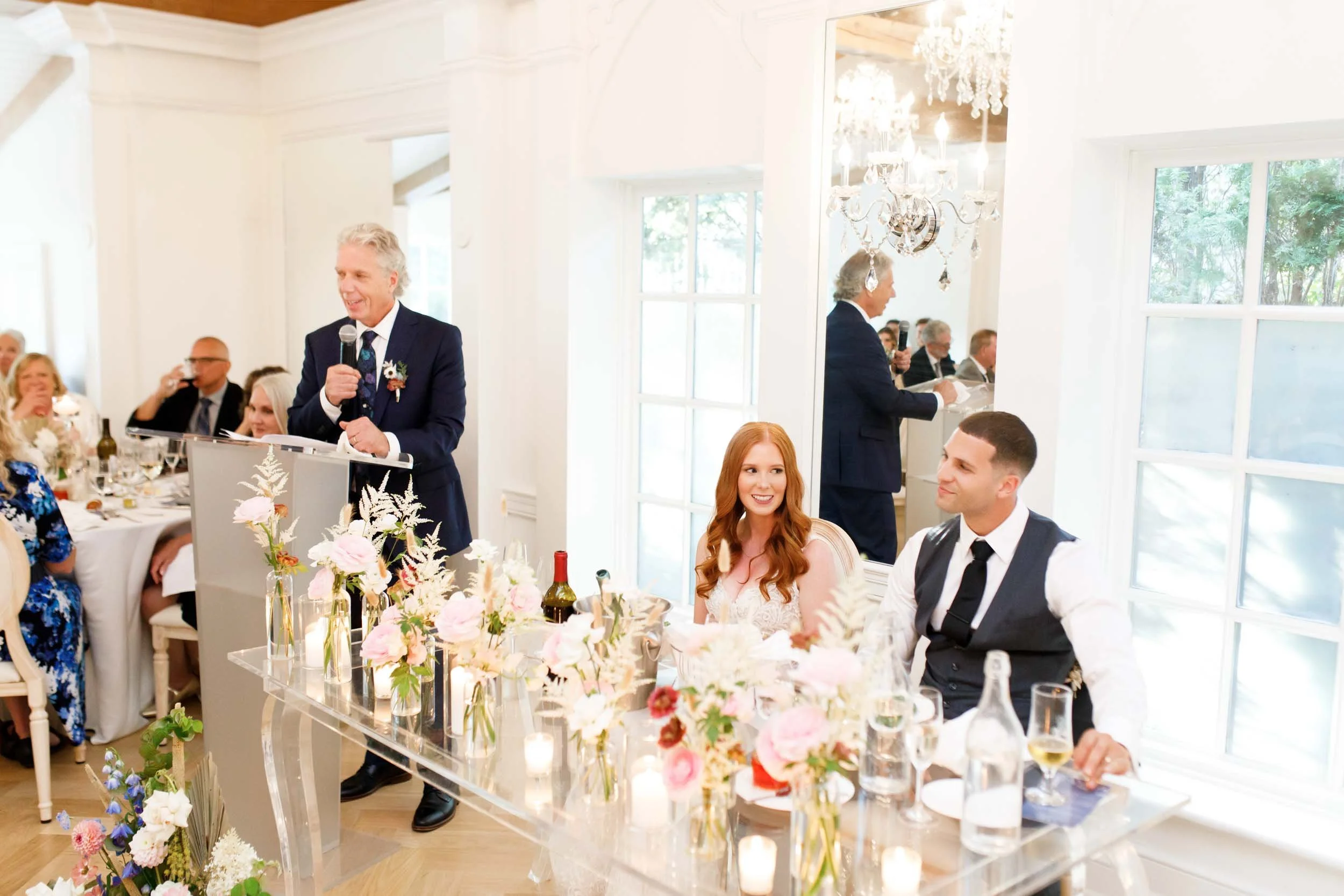 Bride and groom at head table during speeches at The Doctor’s House in Kleinburg