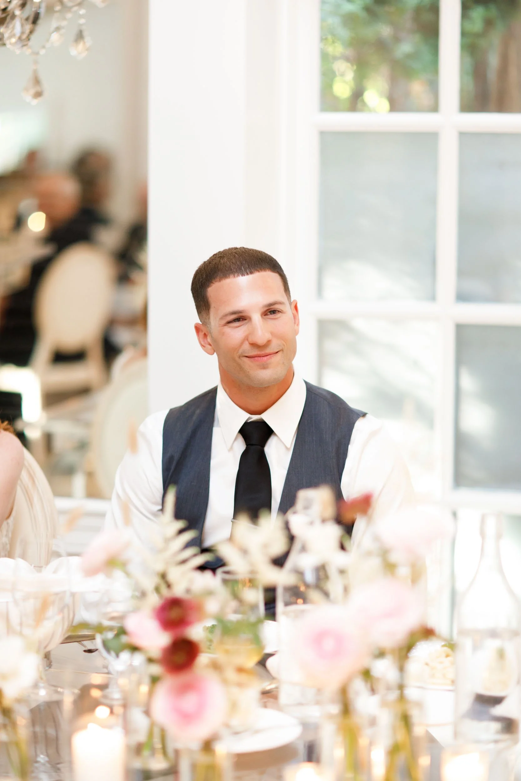 Groom seated at head table at The Doctor’s House in Kleinburg wedding