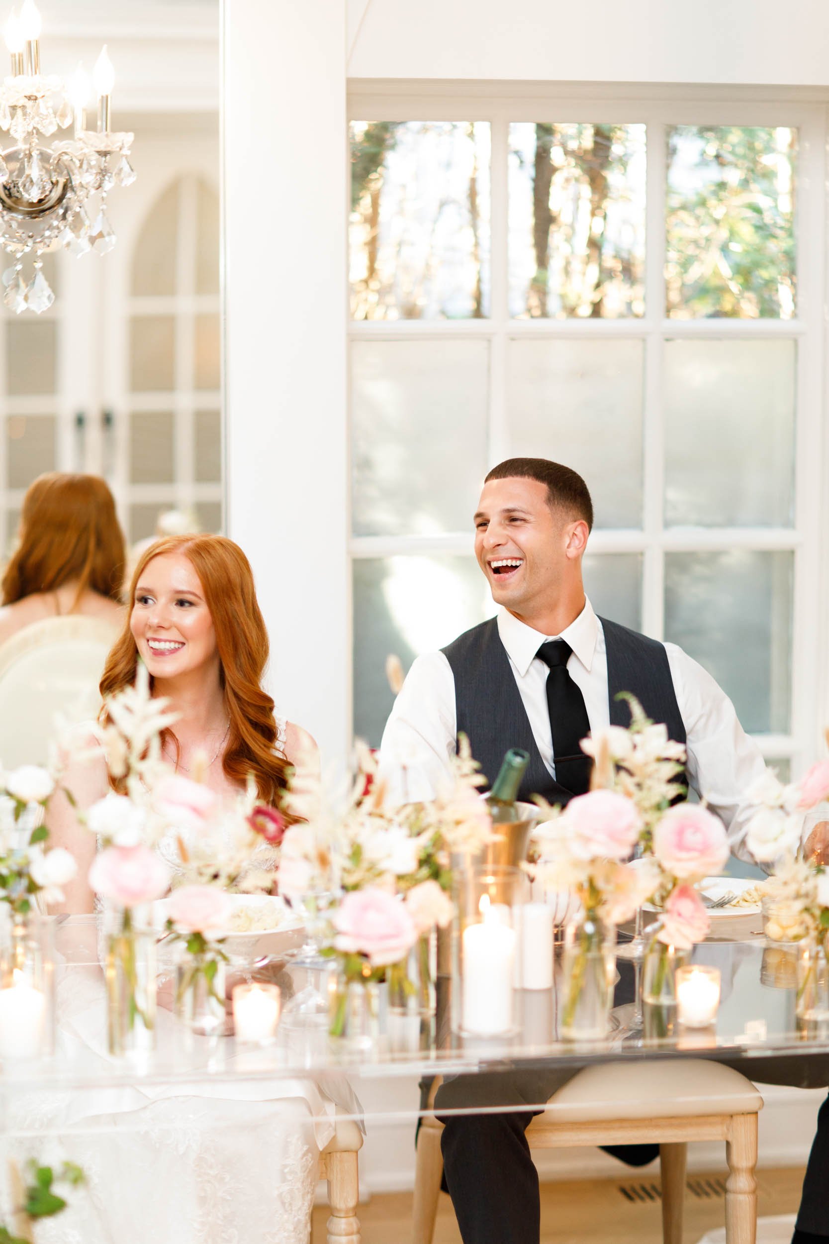 Bride and groom laughing during speeches at The Doctor’s House in Kleinburg
