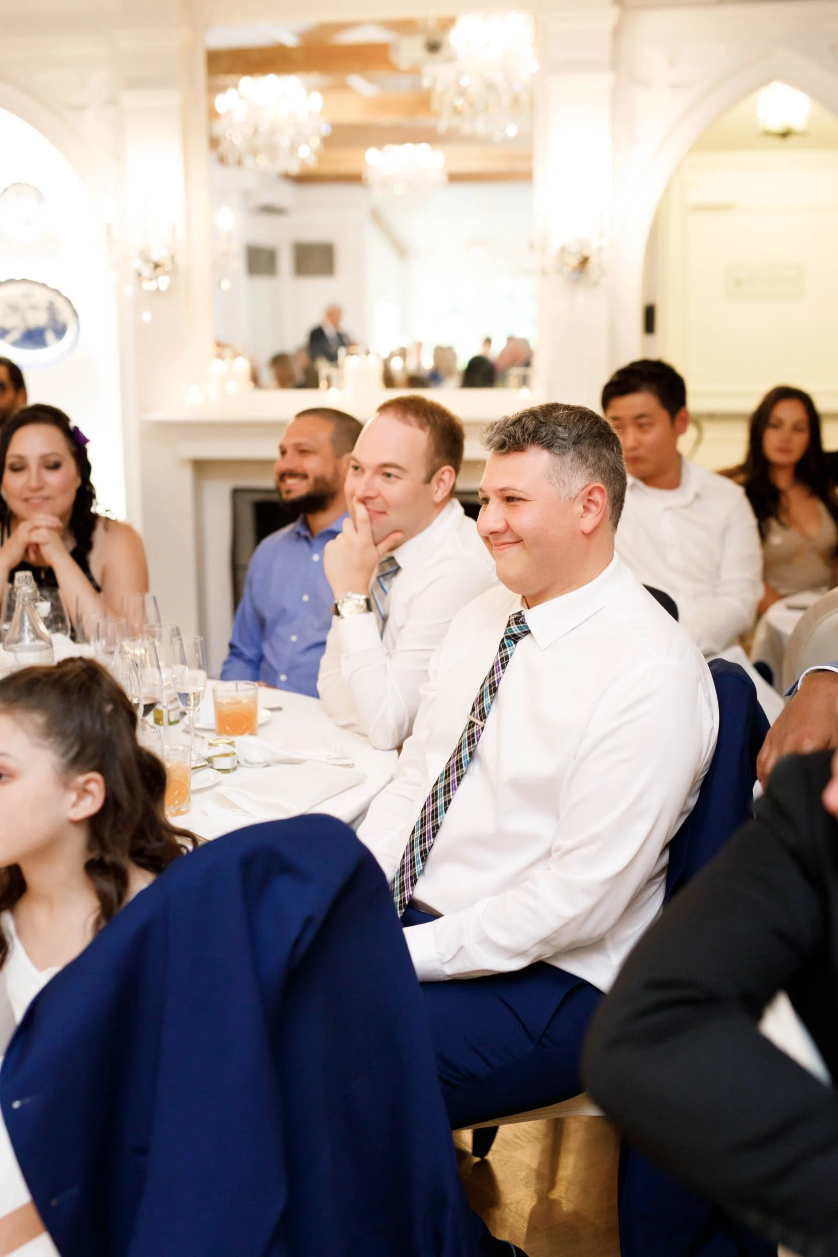 Wedding guests laughing at reception at The Doctor’s House in Kleinburg, Ontario