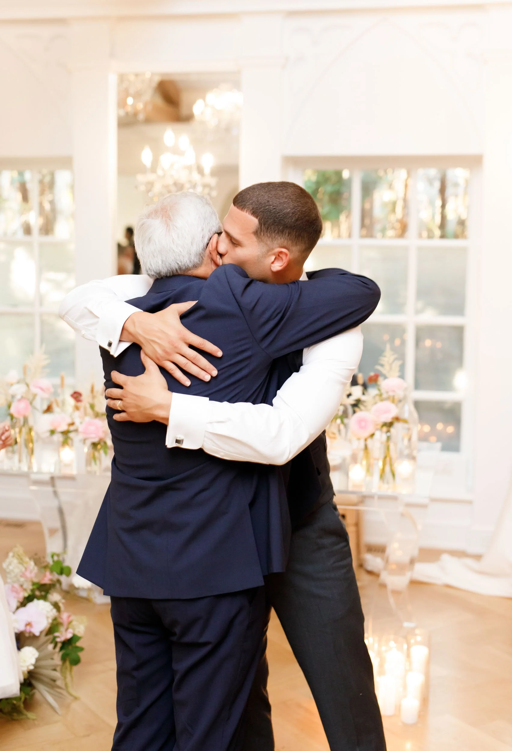 Groom hugging family member at The Doctor’s House in Kleinburg, Ontario wedding