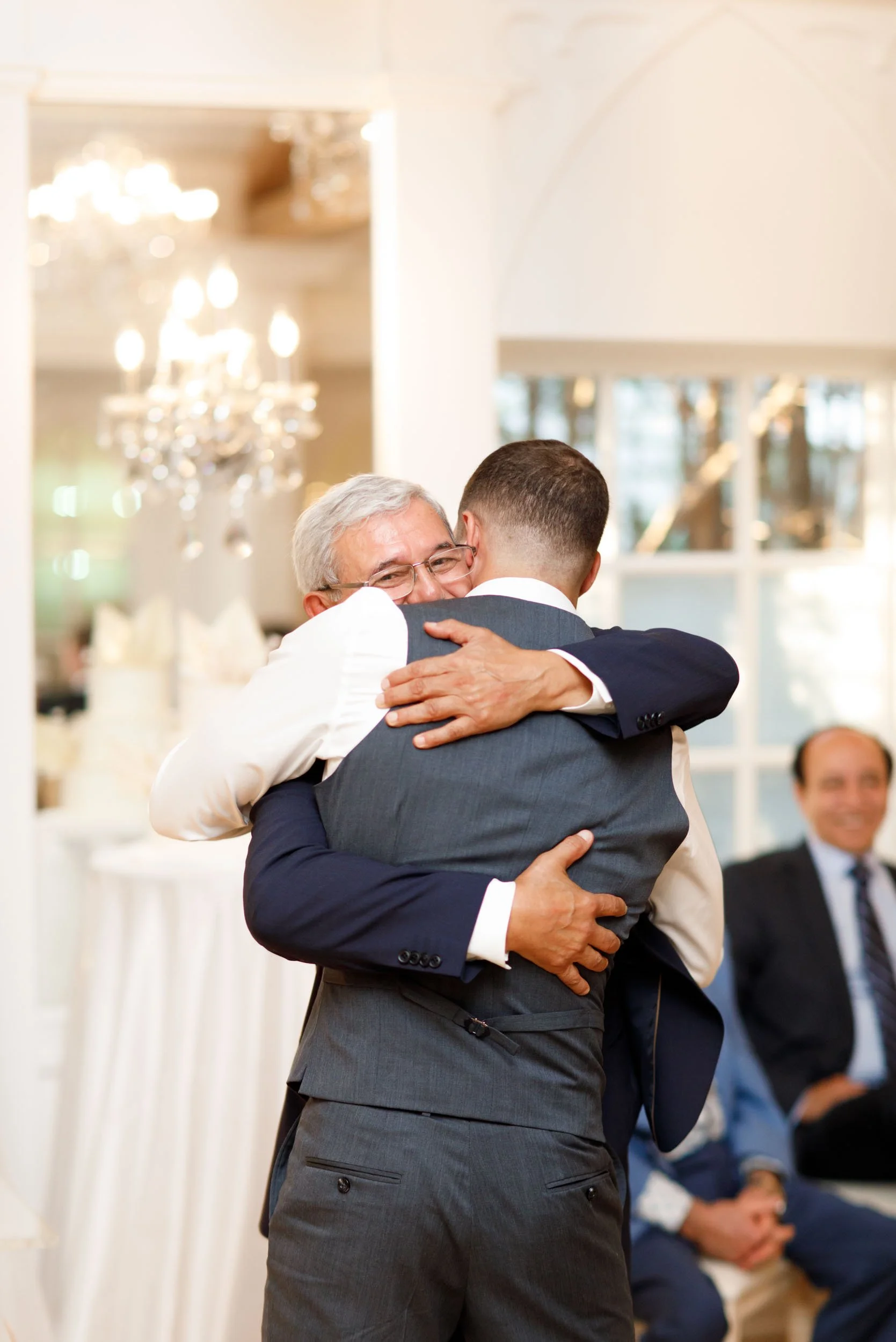 Groom hugging family member at The Doctor’s House in Kleinburg wedding