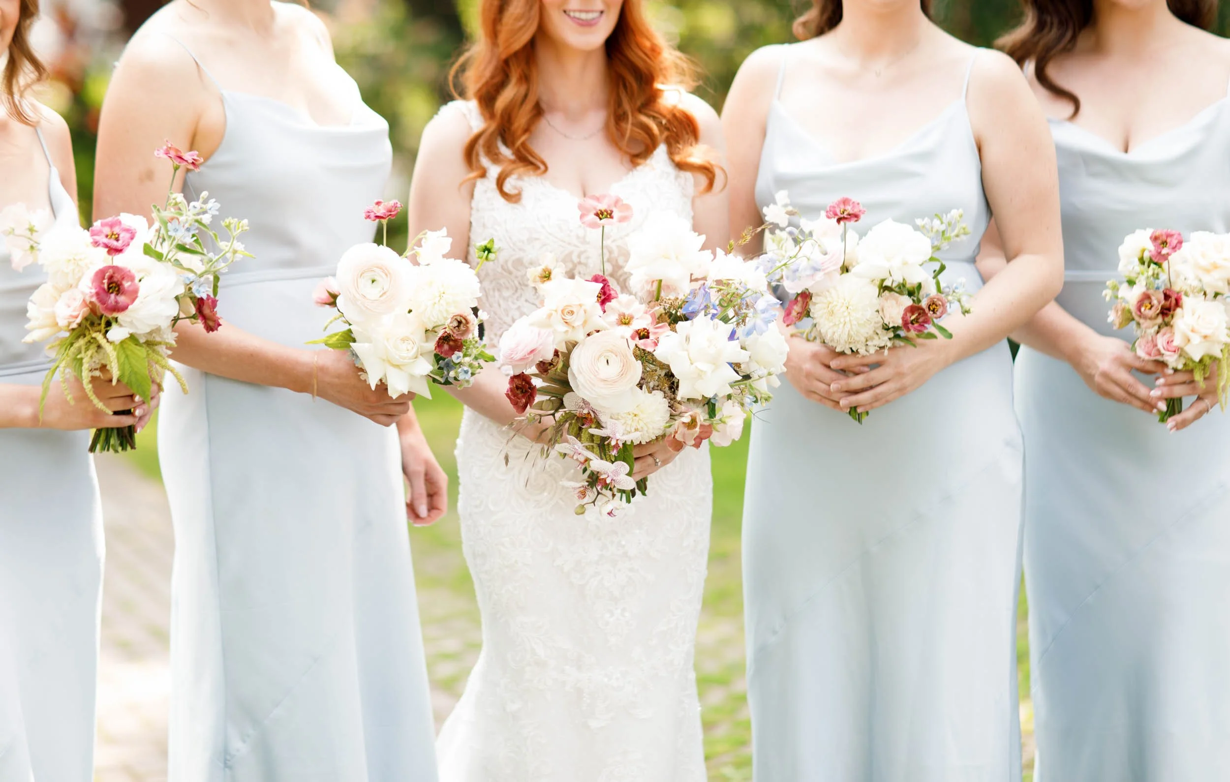 Bride and bridesmaids holding bouquets at The Doctor’s House in Kleinburg