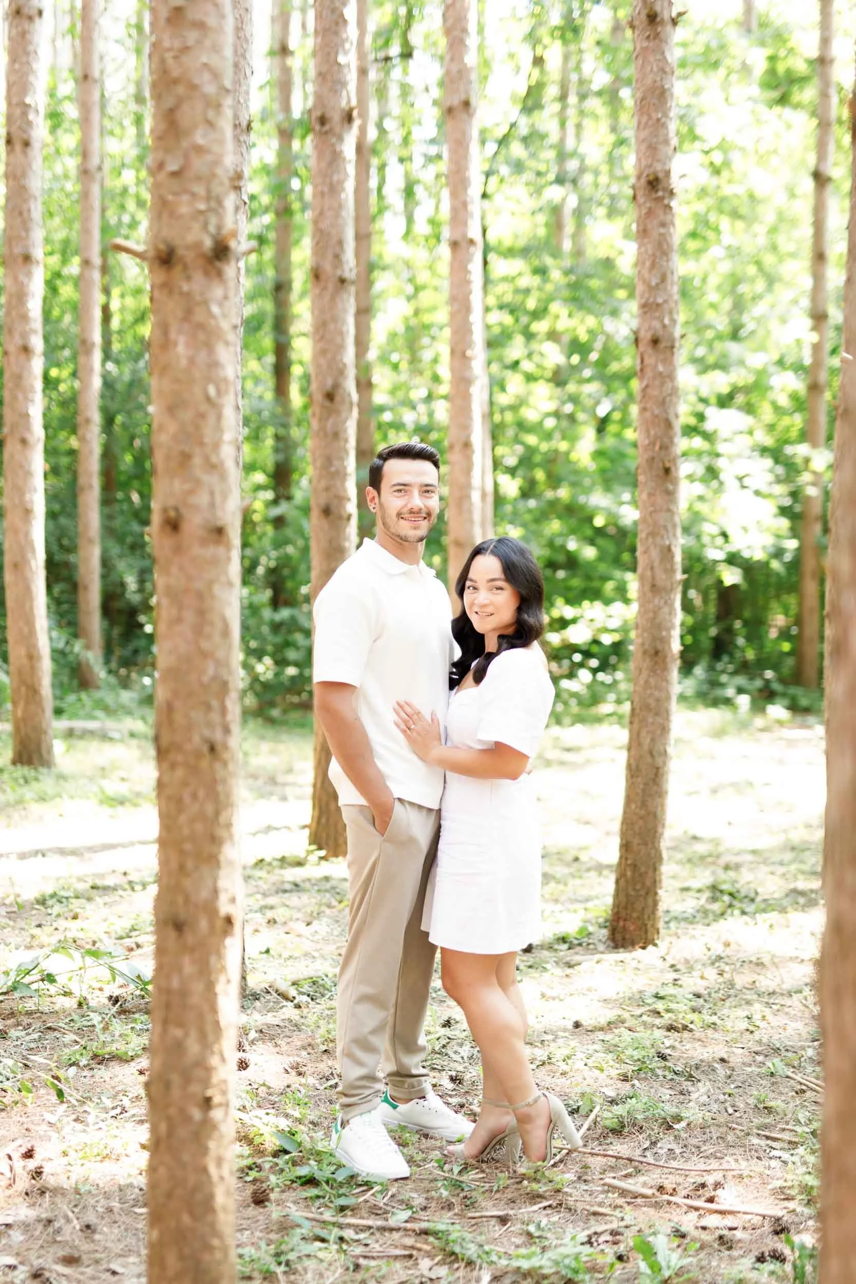 Couple standing together in soft forest light during their Kortright Centre engagement in Woodbridge, Ontario