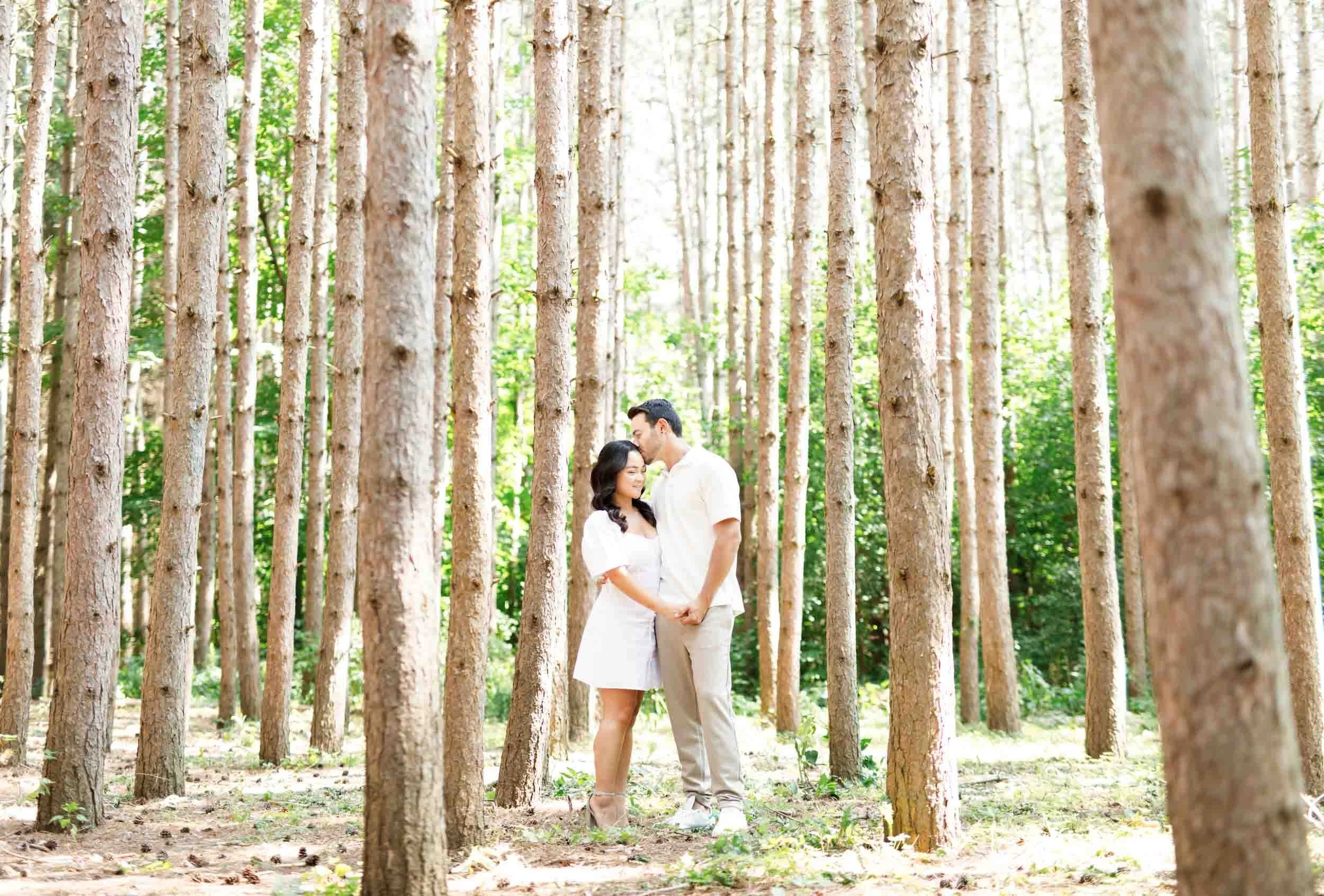 Wide forest scene with couple during their Kortright Centre engagement in Woodbridge, Ontario