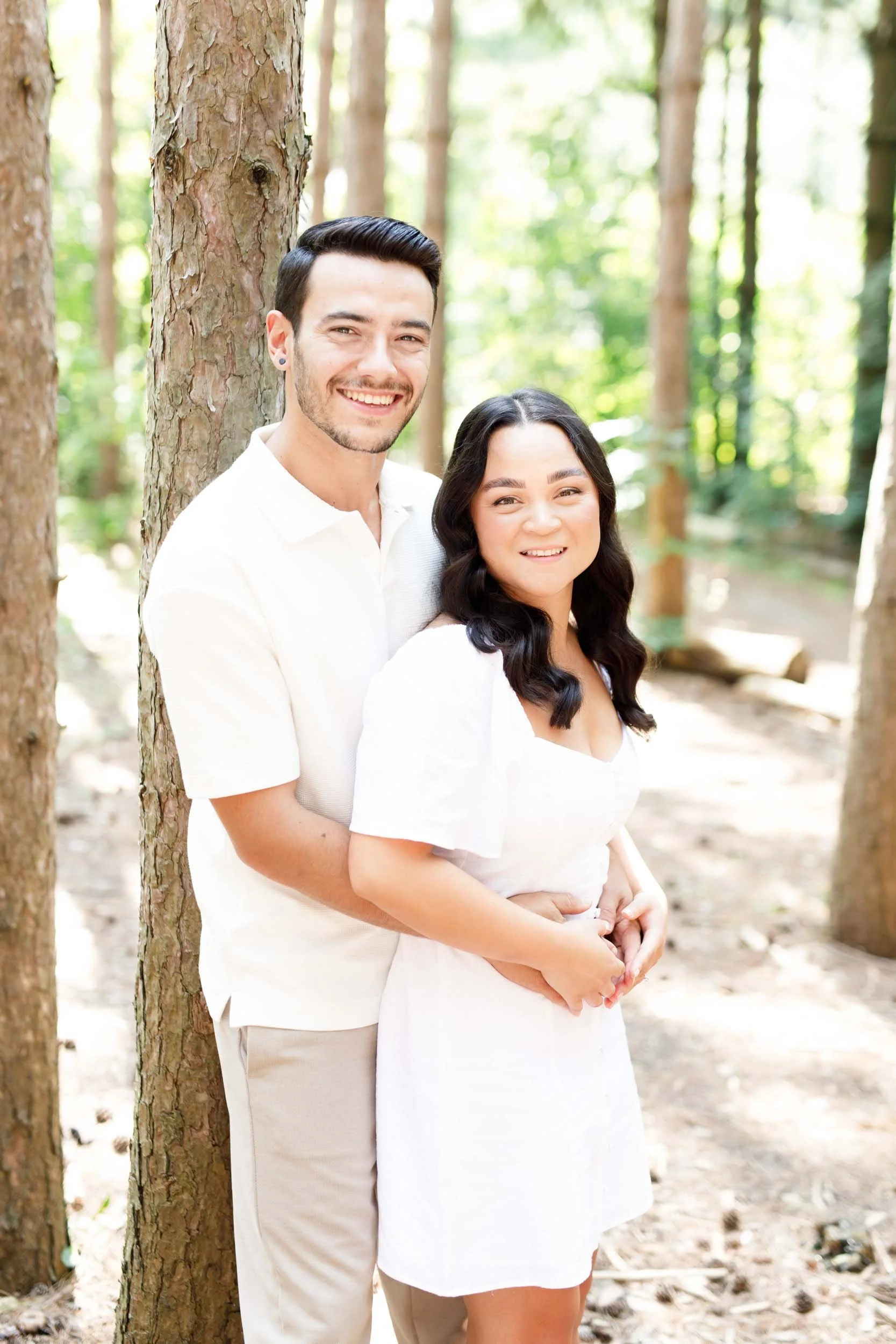 Couple smiling at the camera during engagement photos at Kortright Centre in Woodbridge, Ontario