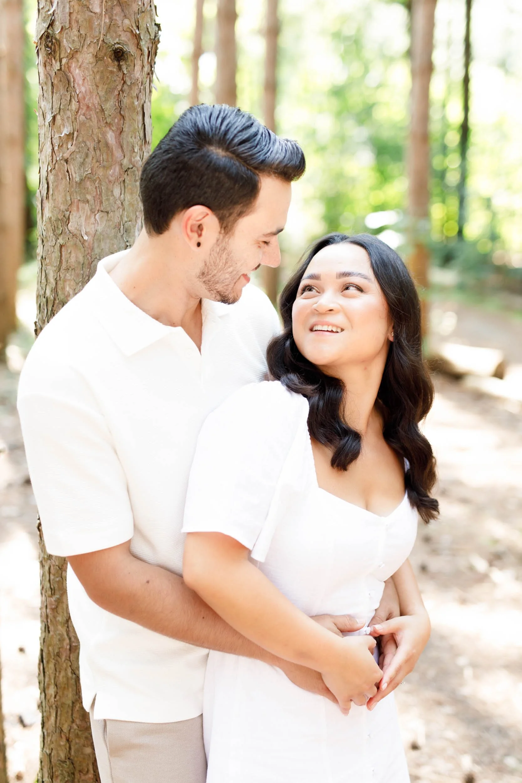 Couple smiling at each other during their Kortright Centre engagement session in Woodbridge, Ontario
