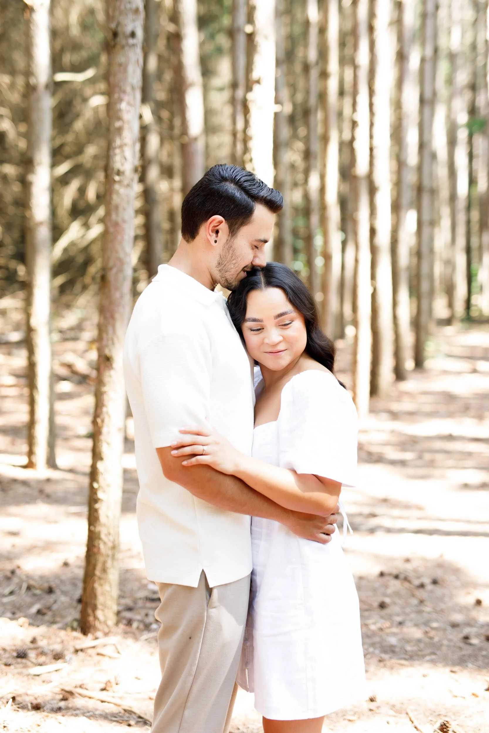 Groom holding bride during engagement photos at Kortright Centre in Woodbridge, Ontario